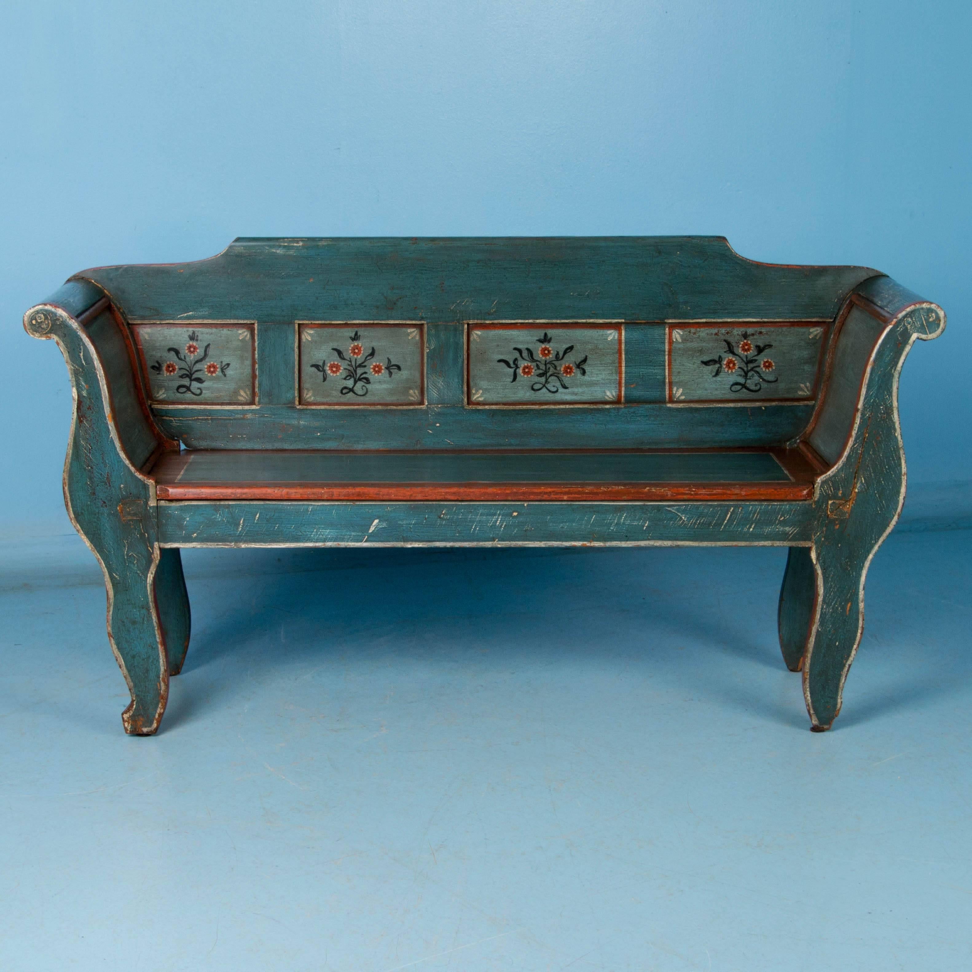 This beautifully painted country pine bench is a special find, unusual because of its abbreviated size. The delightful vintage blue paint with outlined accents of red and white, was painted approximately 75 years ago in a traditional folk art style