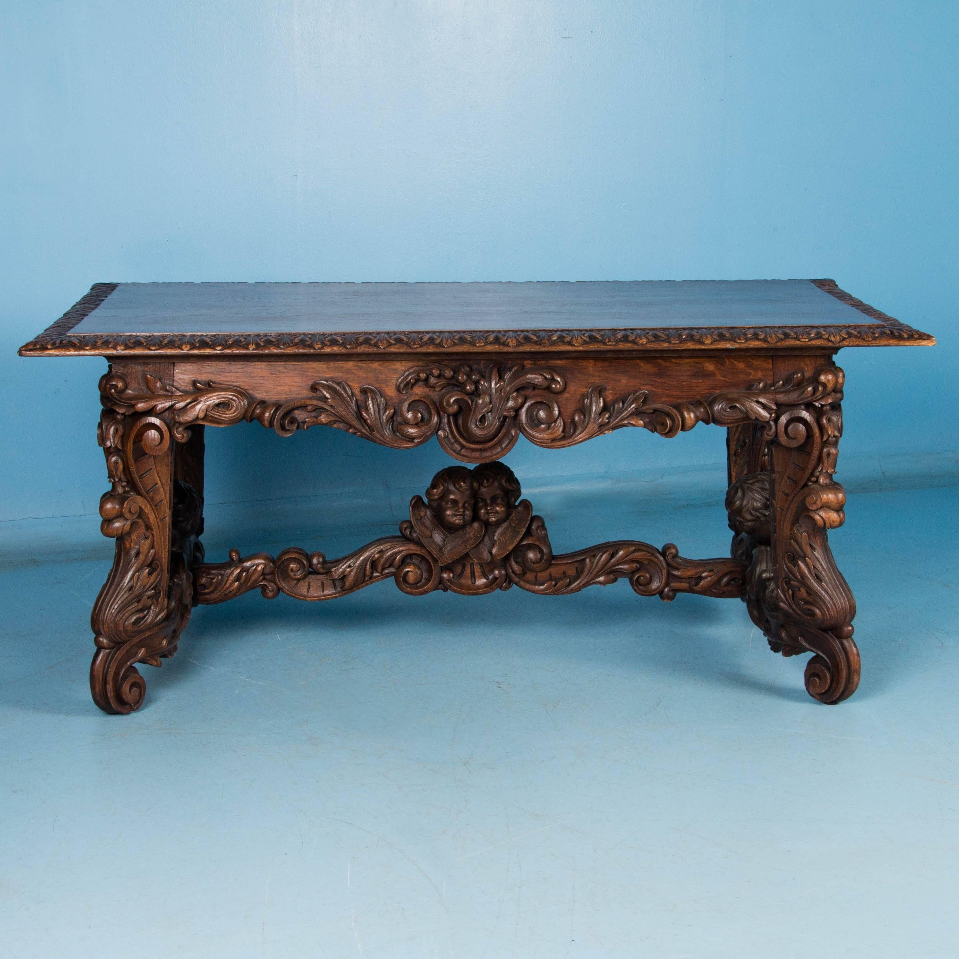 
This highly carved library or entry table is visually stunning due to the exceptional French craftsmanship and elaborate carving throughout the base. The superb details include multiple cherubs, bell flowers, acanthus leaves and more. Made of