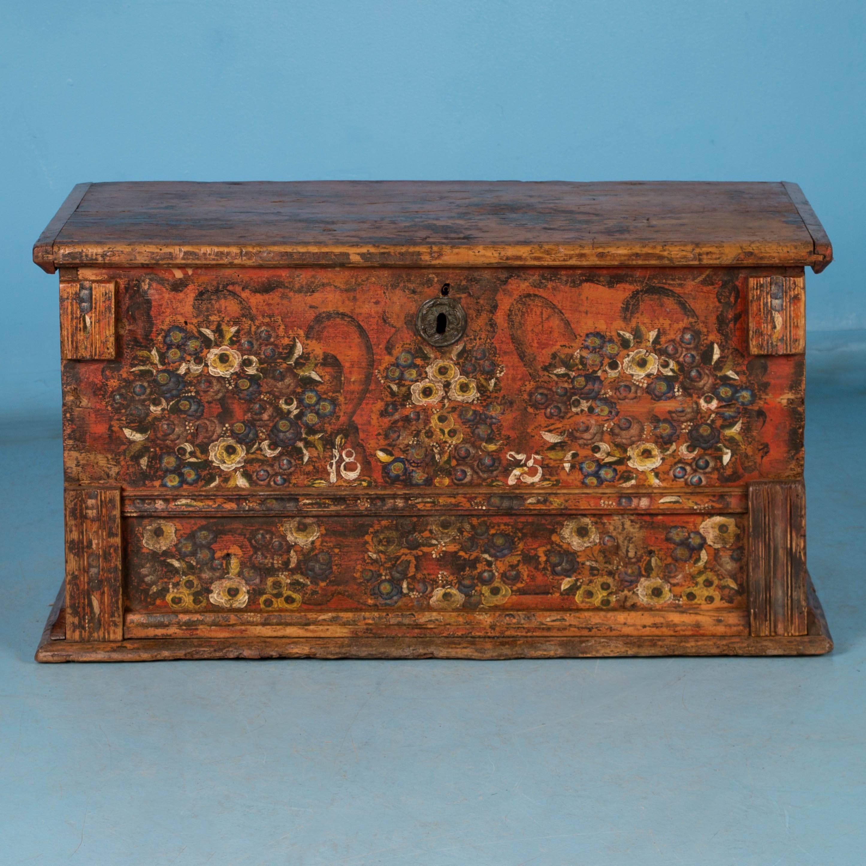 On the front of this trunk, the original painted floral bouquets over a burnt orange background is a great example of Romanian folk art. The flat top allows it to serve many functions in a modern home, including small coffee table, side table,