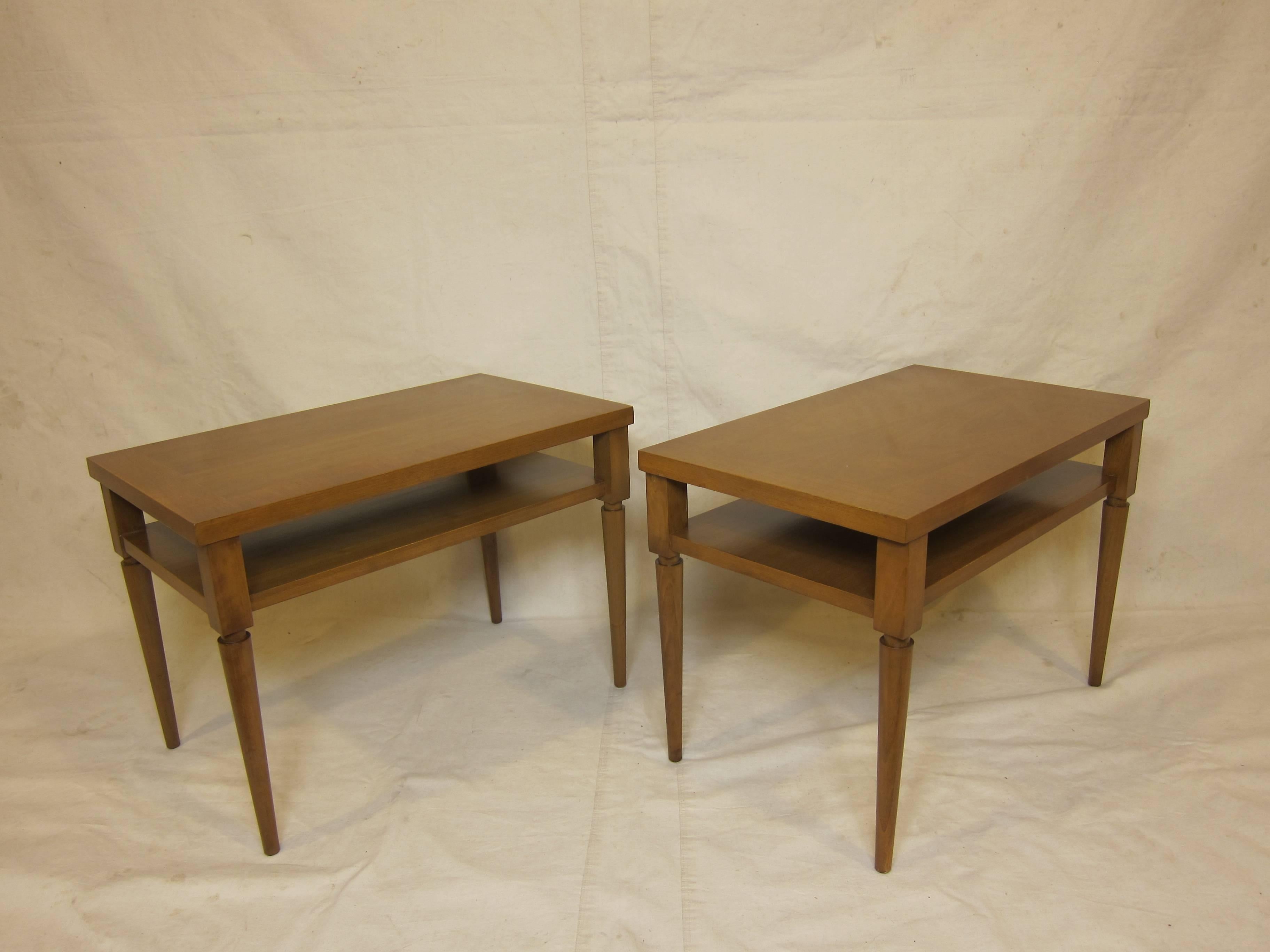 A pair of side tables with banded tops and shelfs designed by Robsjohn Gibbings made by Widdicomb.  Original color in excellent condition.   
