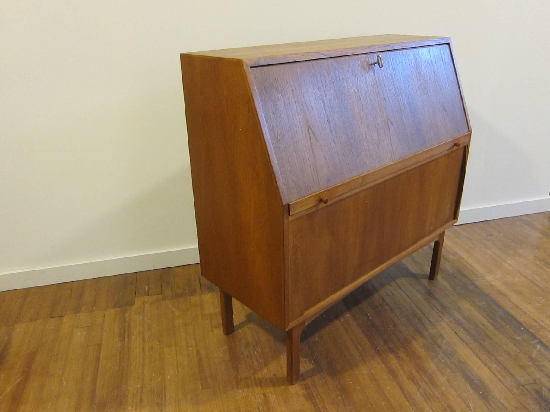 Bernhard Pedersen & Son secretary desk with drop-front desk work area with tambour door storage cabinet, circa 1950s. A very hard piece to find by one of the premier Danish makers of the period. In very good condition.