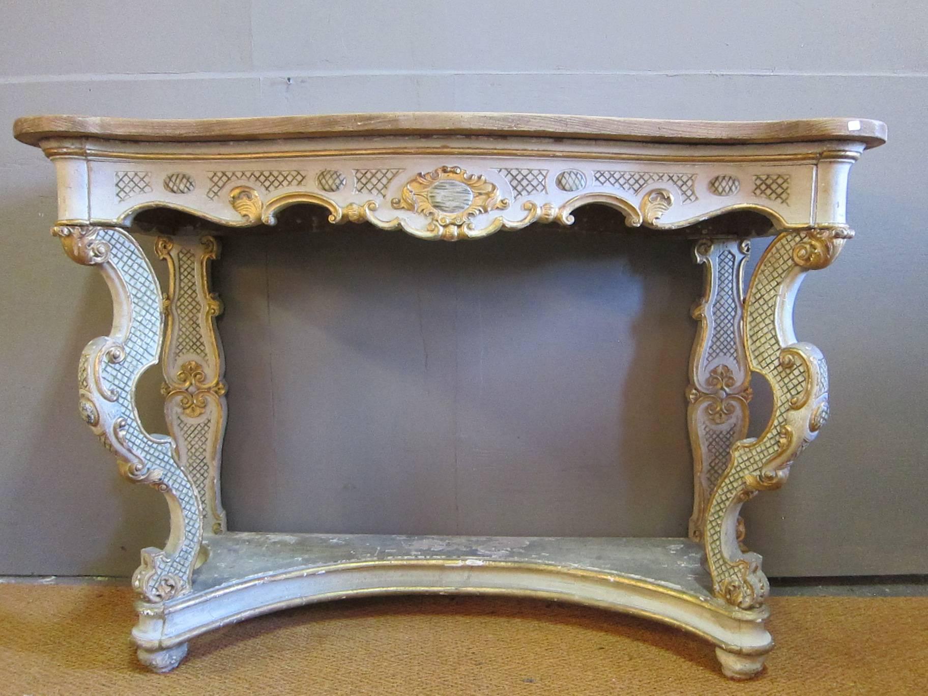 Early 19th century Italian Baroque console table. A painted console with gesso, exposed wood top, legs on raised plinth with ball feet. Very individual having large-scale with tremendous presence.