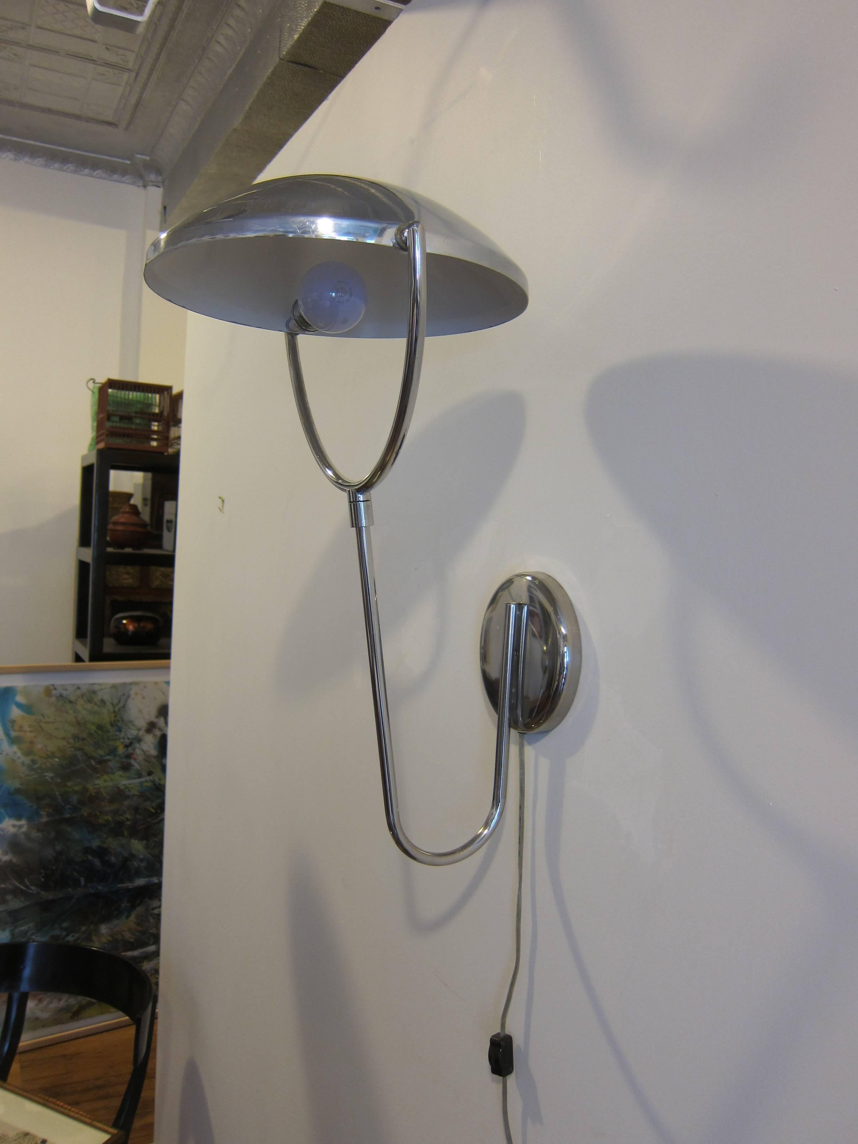 A rare Laurel articulating wall-mounted lamp sconce. The dome shade rotates, rotation allowing for various directions of light up or down. The arm that holds the shade rotates 300% from left to right allowing for the light to be directed to the
