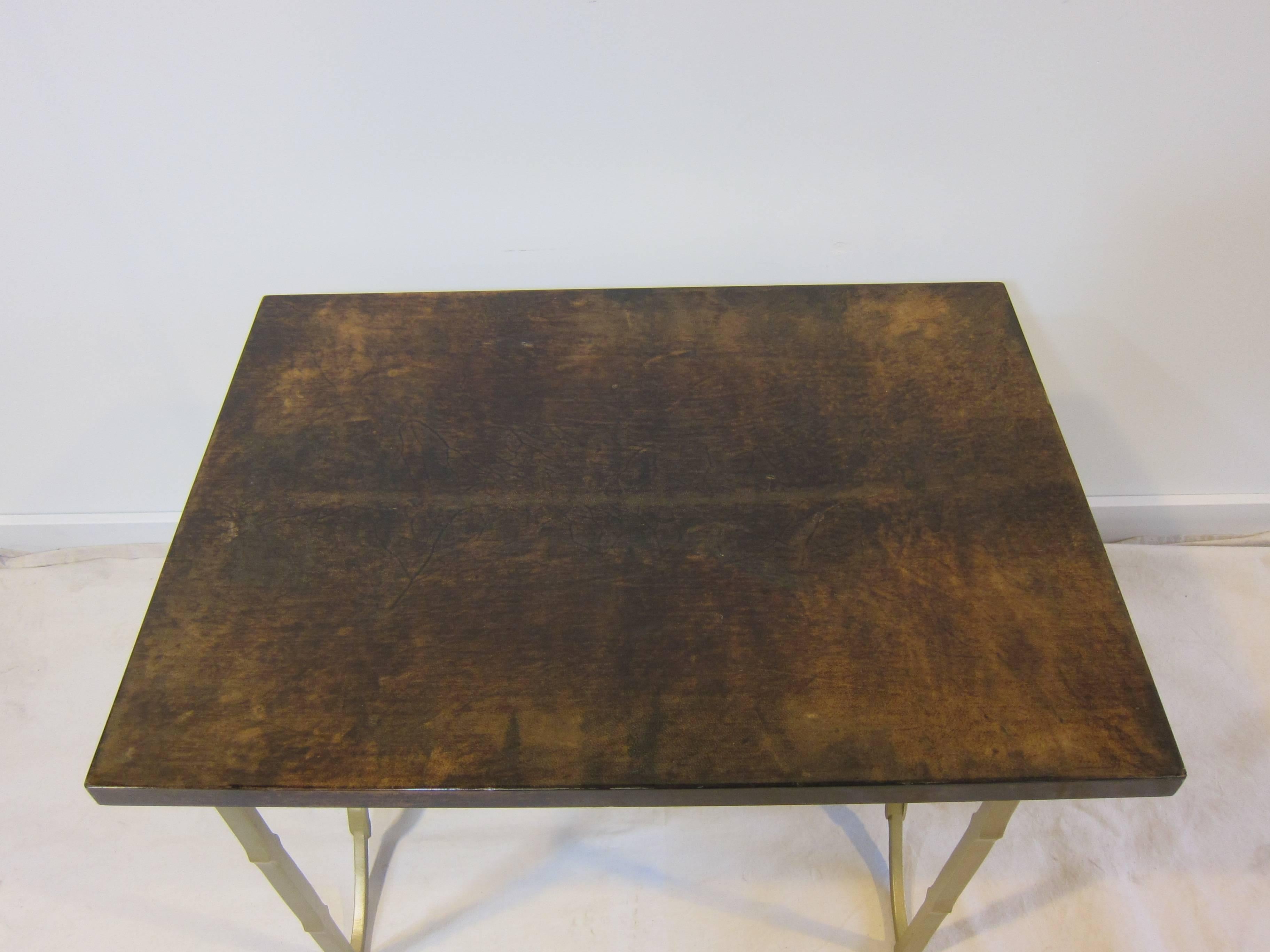 Aldo Tura goatskin lacquered side or end table with decorative metal base. 
The Aldo Tura label to underside. Good condition with some scratches and nicks to the top. Wear consistent with age and use.