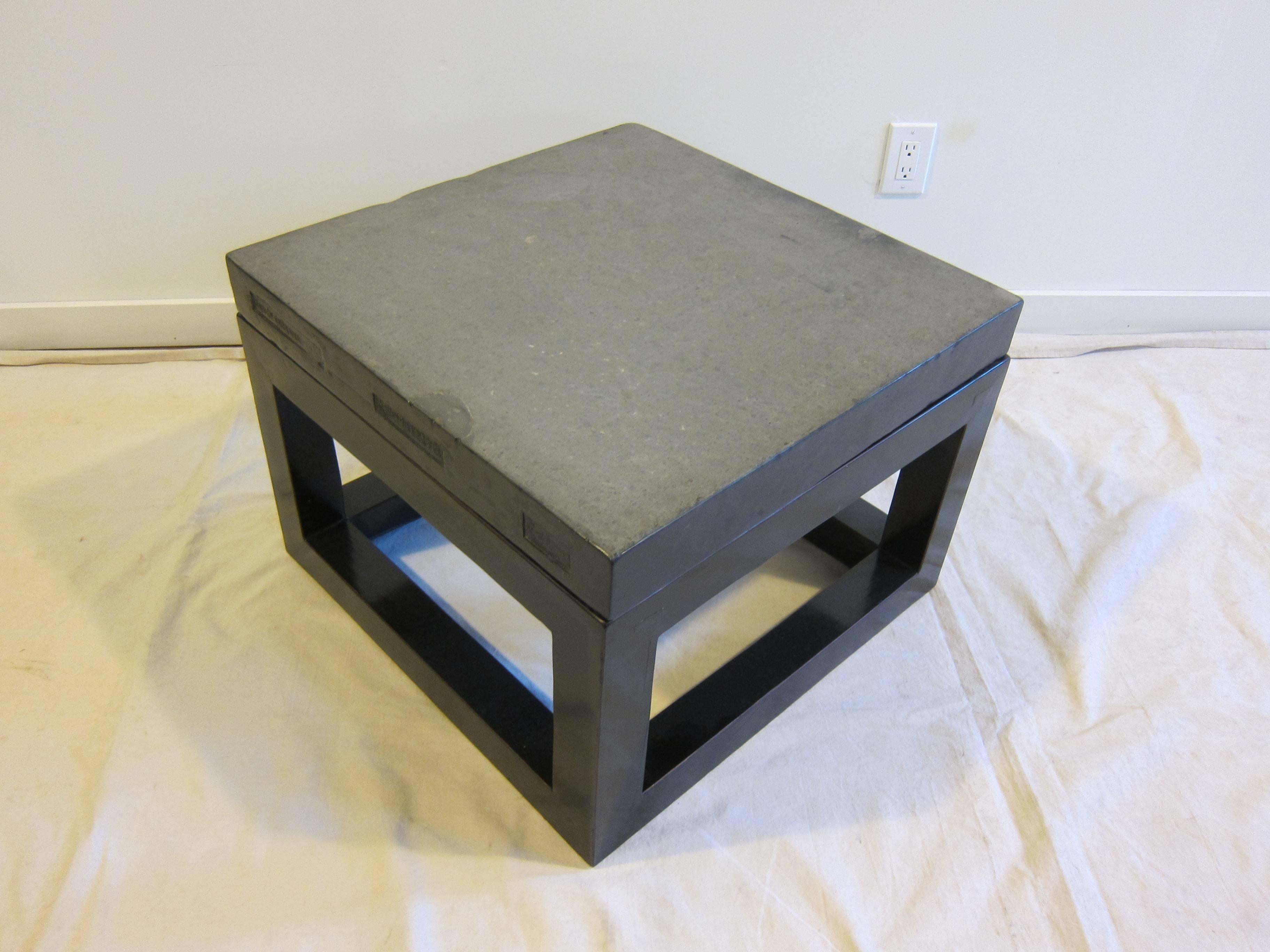 Chinese Ming style stone top table. Old floor stone with inscribed markings of Qing dynasty on elmwood black lacquer Table base.  The stone is inscribed with Chinese characters showing its history.  In very good condition.