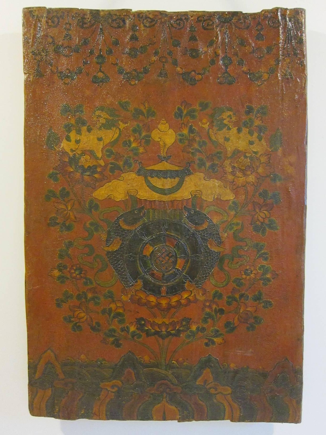 Tibetan painted door, circa 1900. A canvas is applied to the door face and decorated using pigments (mineral colors) and lacquer. This door has strong patina showing age with raised lacquer work. An excellent example of Tibetan art and culture. 


