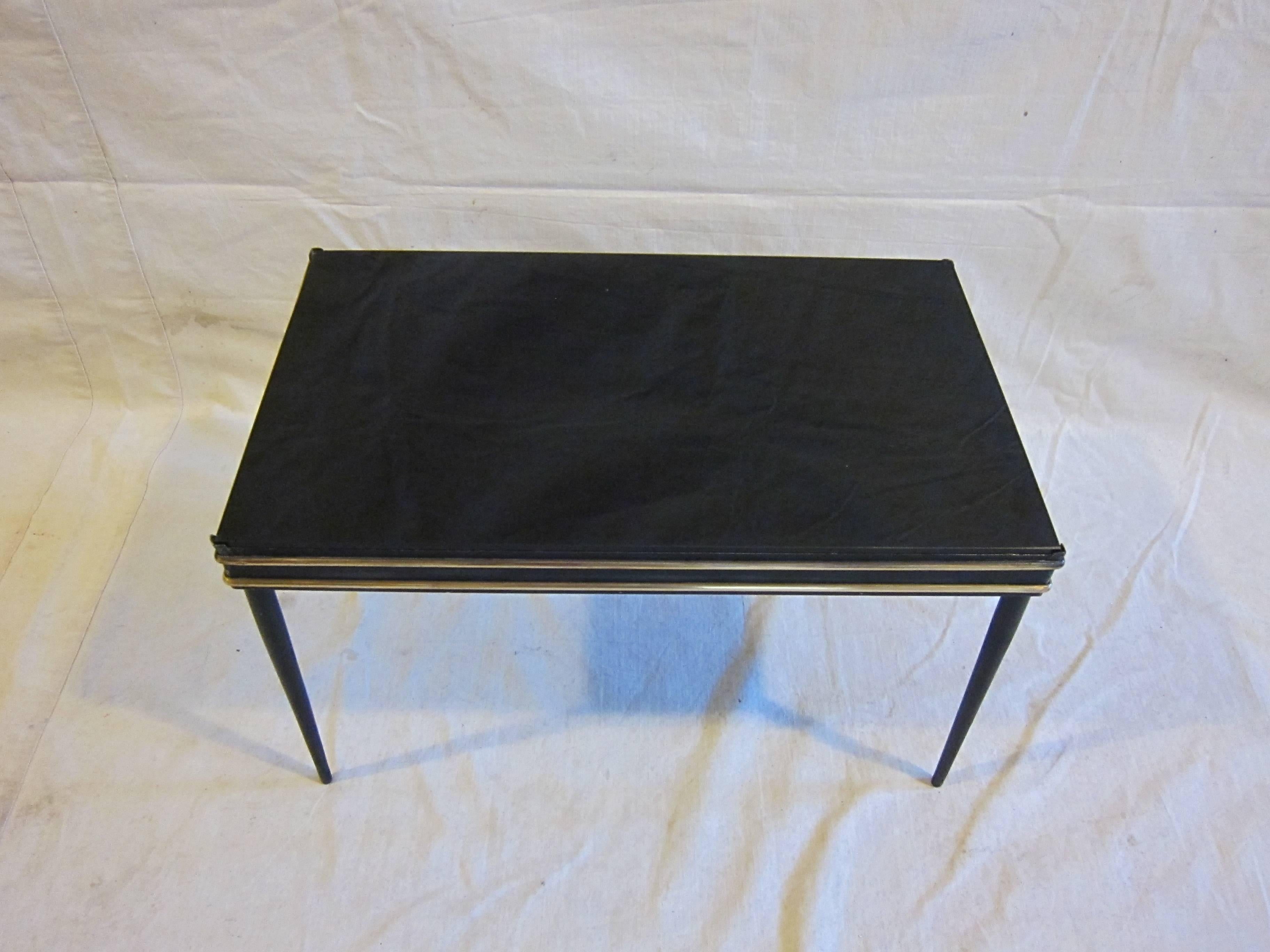 Italian Stiletto leg cocktail side table in the style of Fontana Arte. Black steel frame with double brass bands raised on stiletto styled legs having a black glass top. A diminutive size that is very place able as a side table, drinks table, book