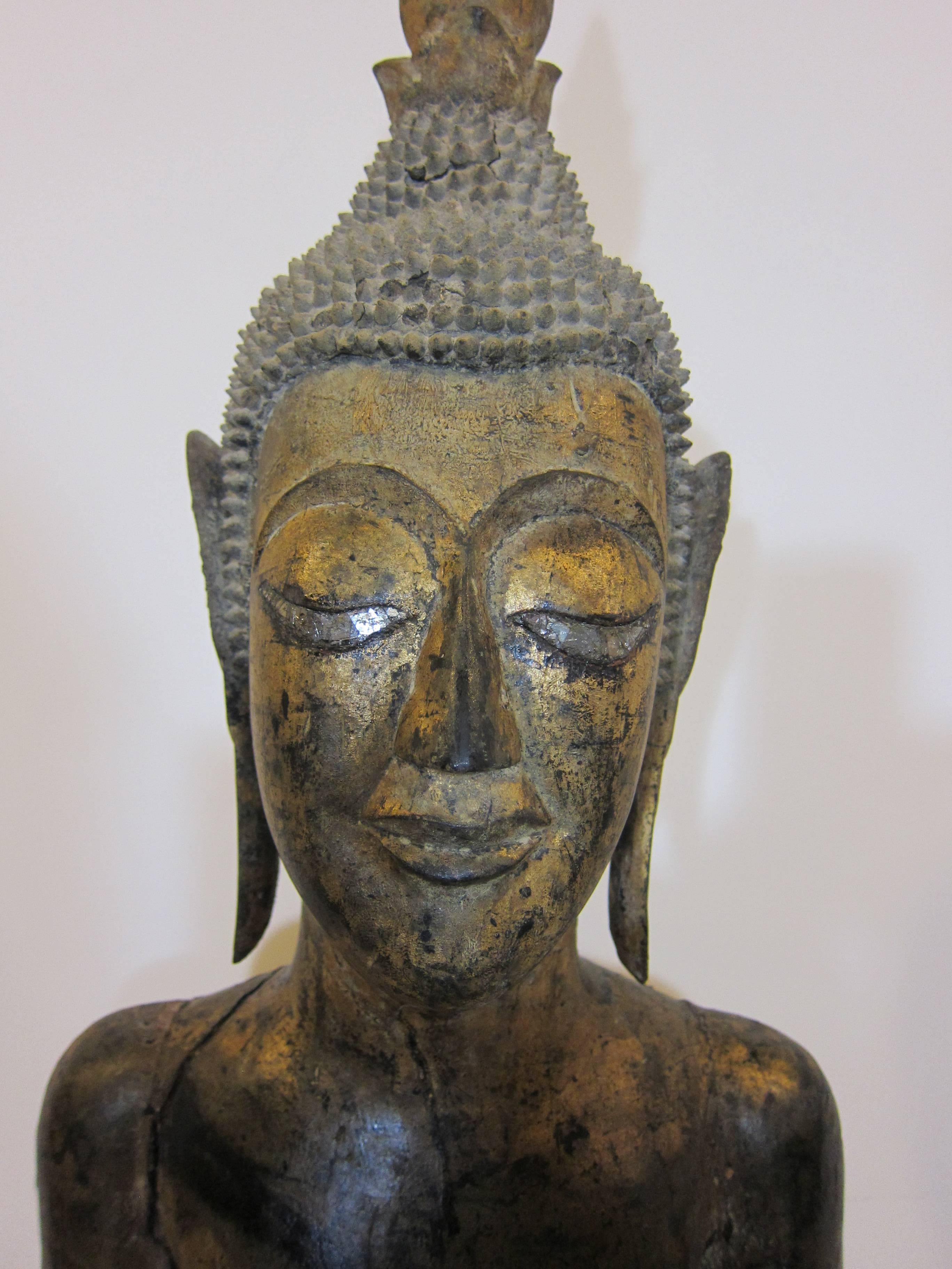 19th century Lao Buddha (Life like size). Late Era: Second period (1827-1893)
Wonderful example of Laotian Buddhist Folk Art. The art of the Lao Buddha image is considered one of the most sought after. This example wooden carved slender body
