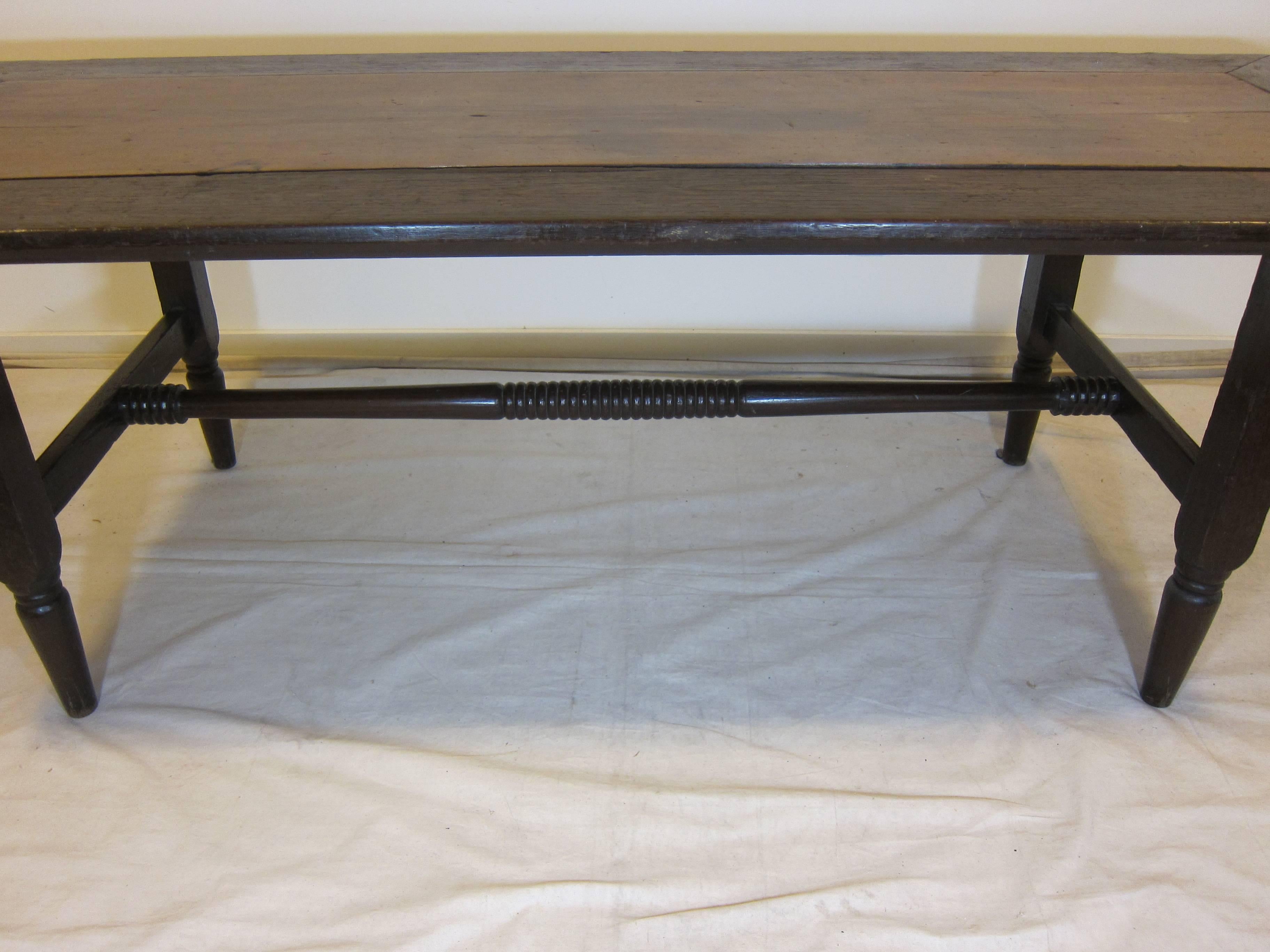 19th century refectory dining table made of Molave and Narra wood.
Spanish colony from the Philippines. The table has a frame of Narra wood with a Molave wood center on top. A center trestle exhibits carved turned center and end. Table is in good