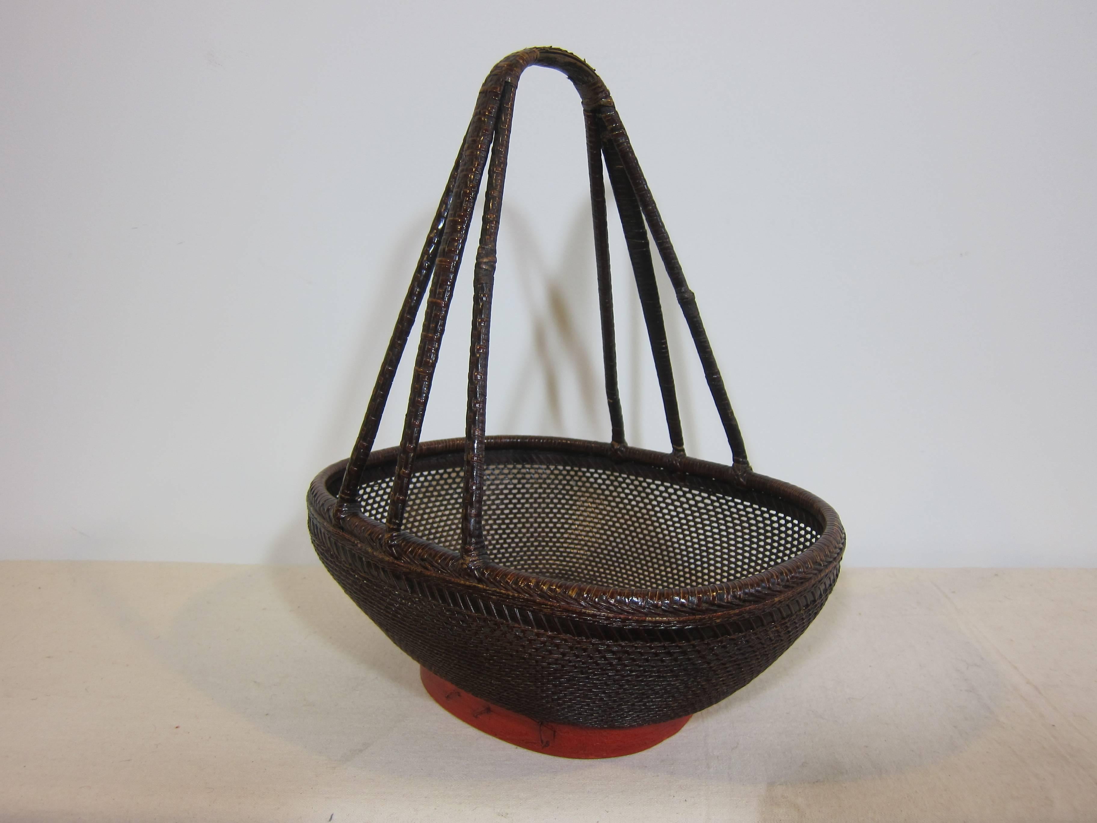 Antique market basket of woven reed, turned bamboo and wood. Decorative basket. This an actual market basket from the turn of the century 1900. In very good condition for collection and or use. Very intricate design with great attention to detail.