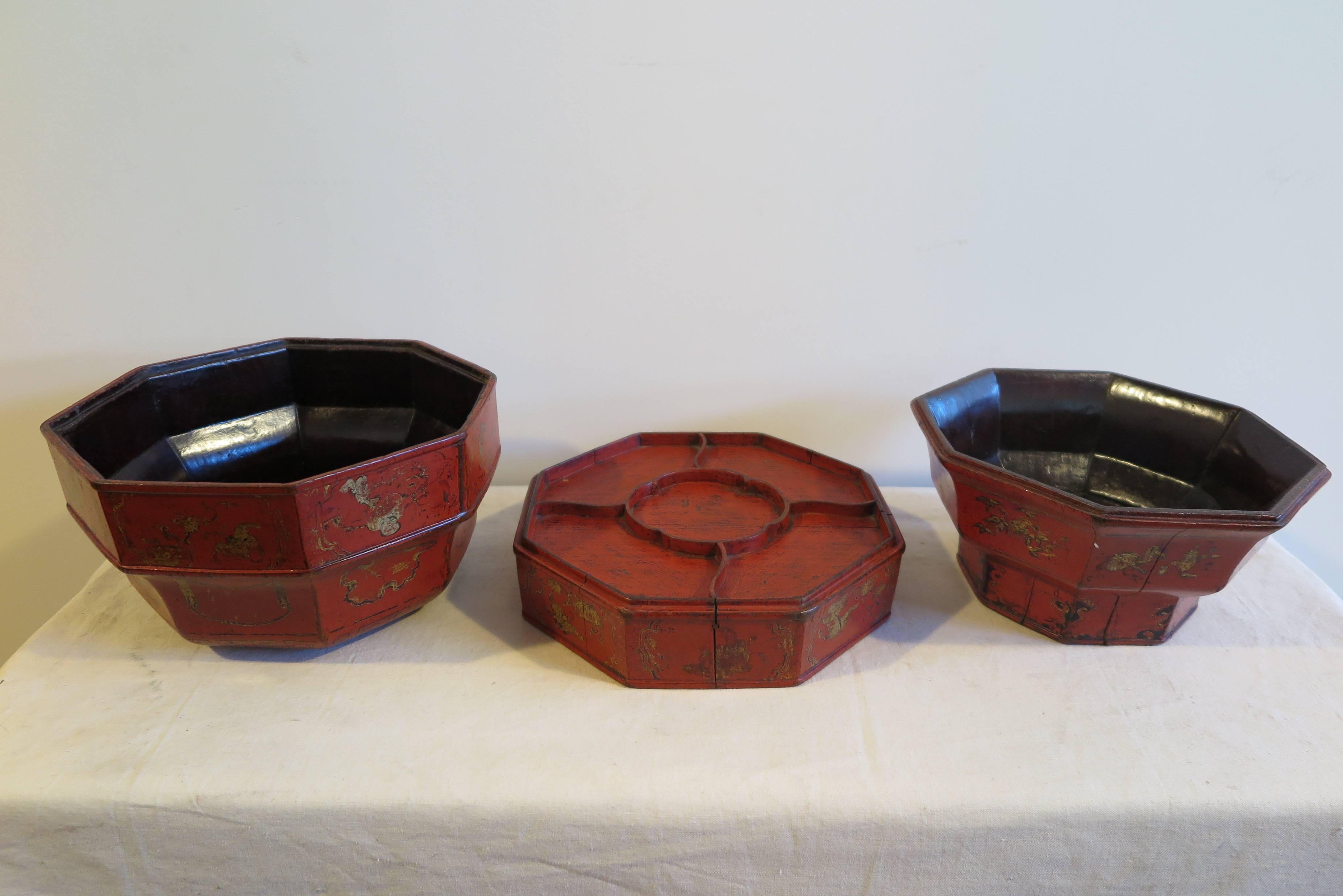 A 18th-19th century Chinese wooden octagon bowl box with gilt painting and red lacquer. Complex three part wooden serving bowl, tray, box. An early 19th century Qing Dynasty Imperial style fruit box. Having three serving pieces, two bowls and one