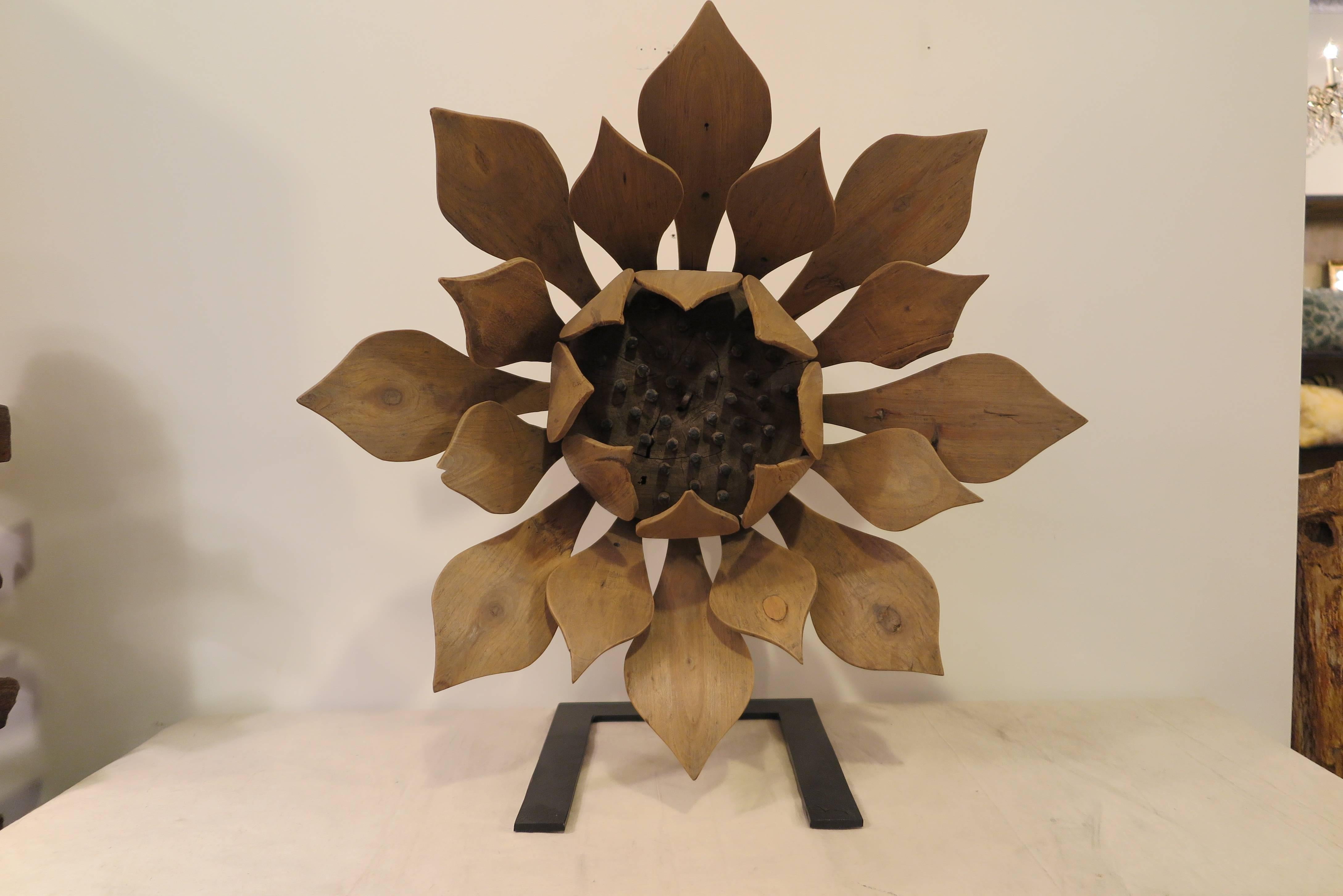 A carved wooden flower sculpture of assembled carved pieces of wood mounted on an iron stand. Very good condition with some signs of repairs made over time. Early 20th century.