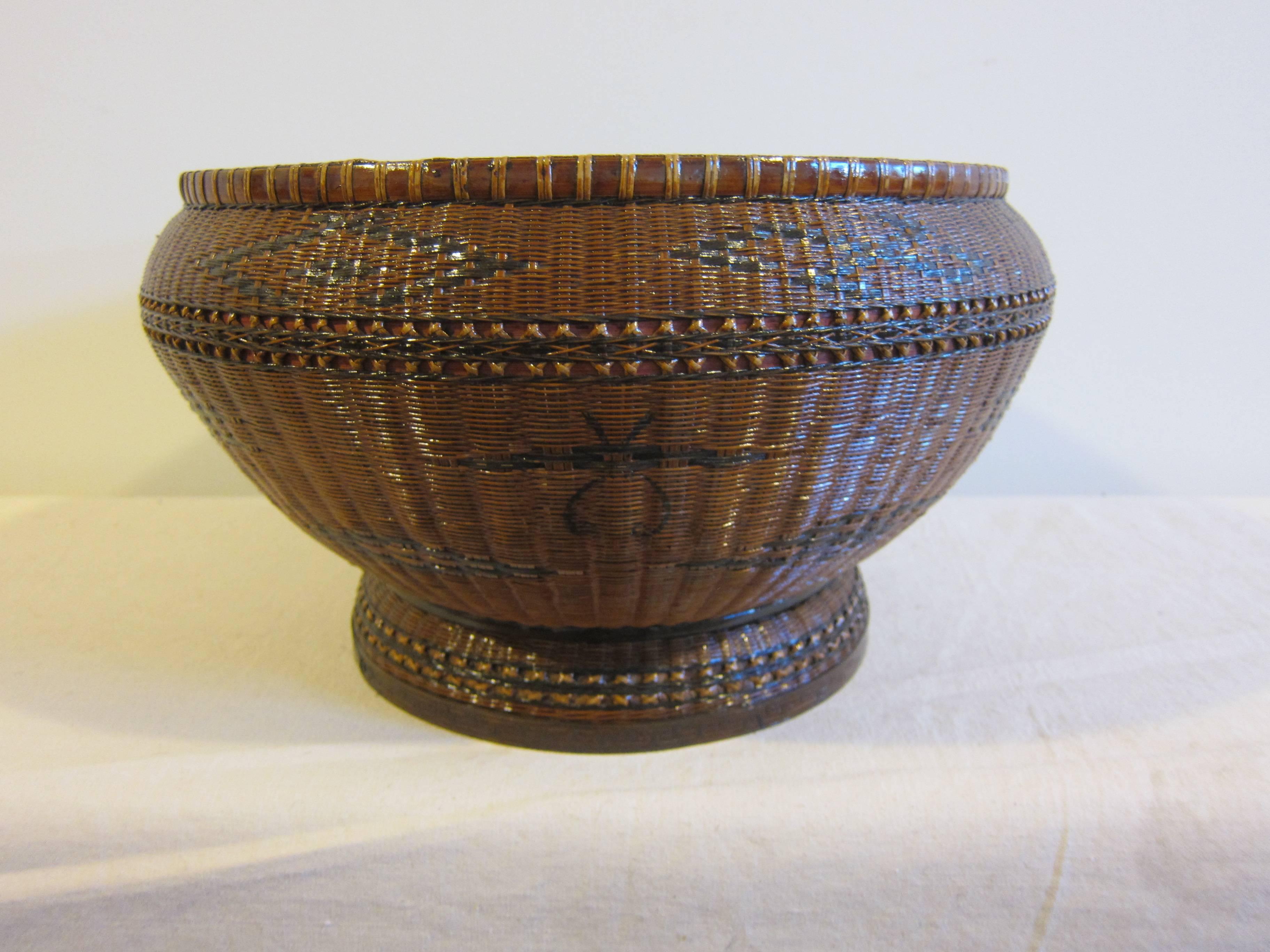 Antique basketry bowl of woven rattan, reed, and bamboo. Wonderful geometric illustrations and complex weaving technique with honeycomb center.
This basket bowl is a utilitarian item that was used in daily. The decoration and patterns are marks of