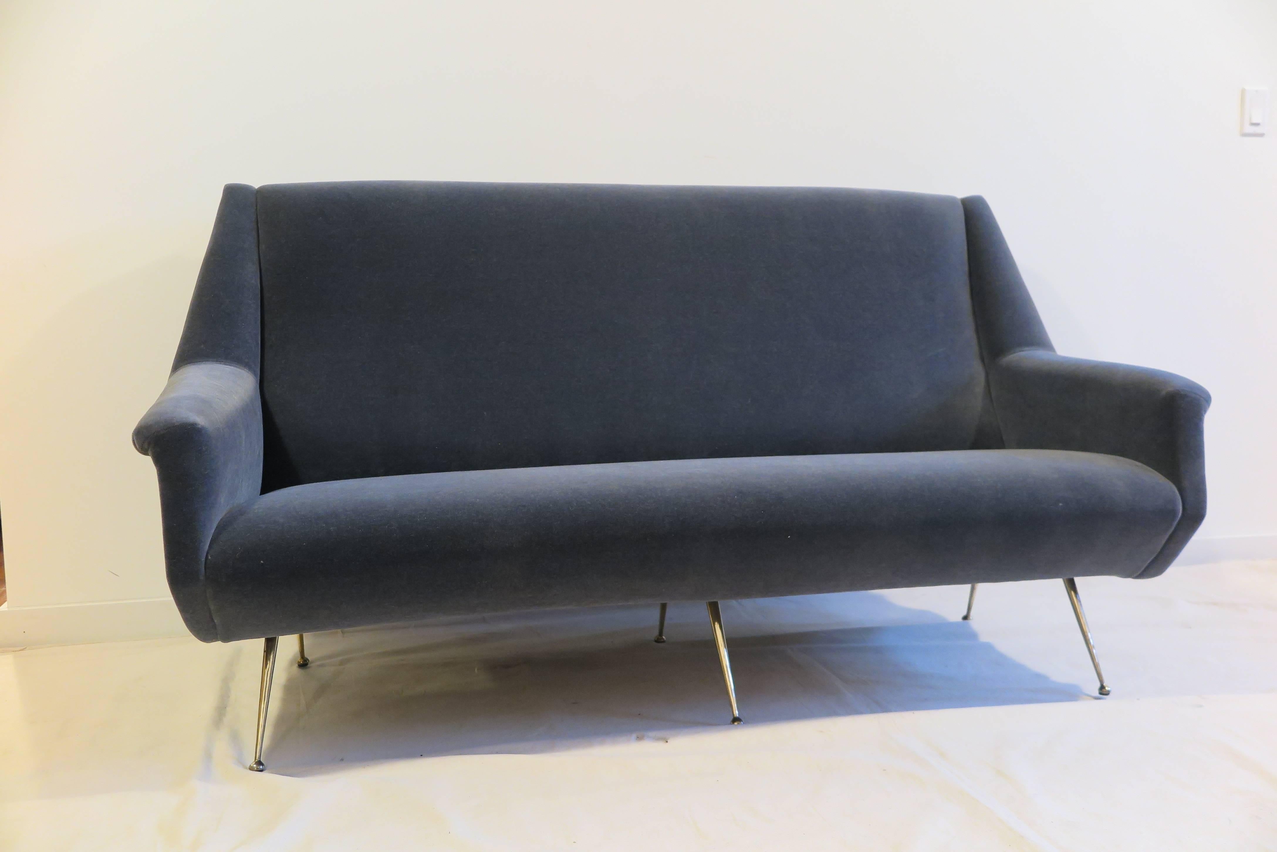 1950 Italian sofa in the style of Gio Ponti. Having 6 brass legs covered in charcoal mohair. An important sofa having straps and signature to frame. Good condition.   