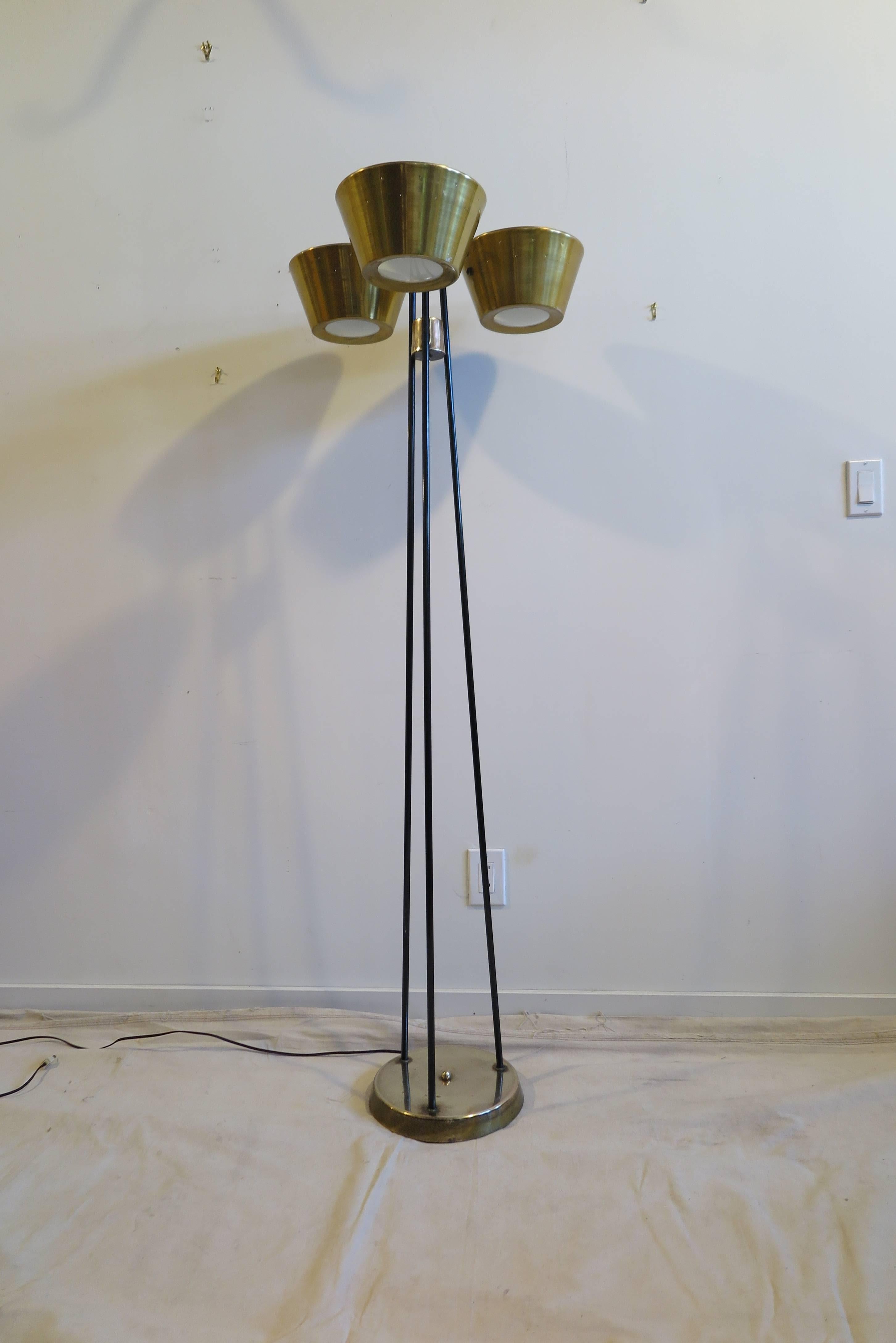 A Gerald Thurston pierced three-light floor lamp touchier for Lightolier. Steel, brass and aluminum floor lamp. Having both downward and upward lighting using a three-way switch that turns 1 on 2 on 3 on 4 off. Very good original condition, with