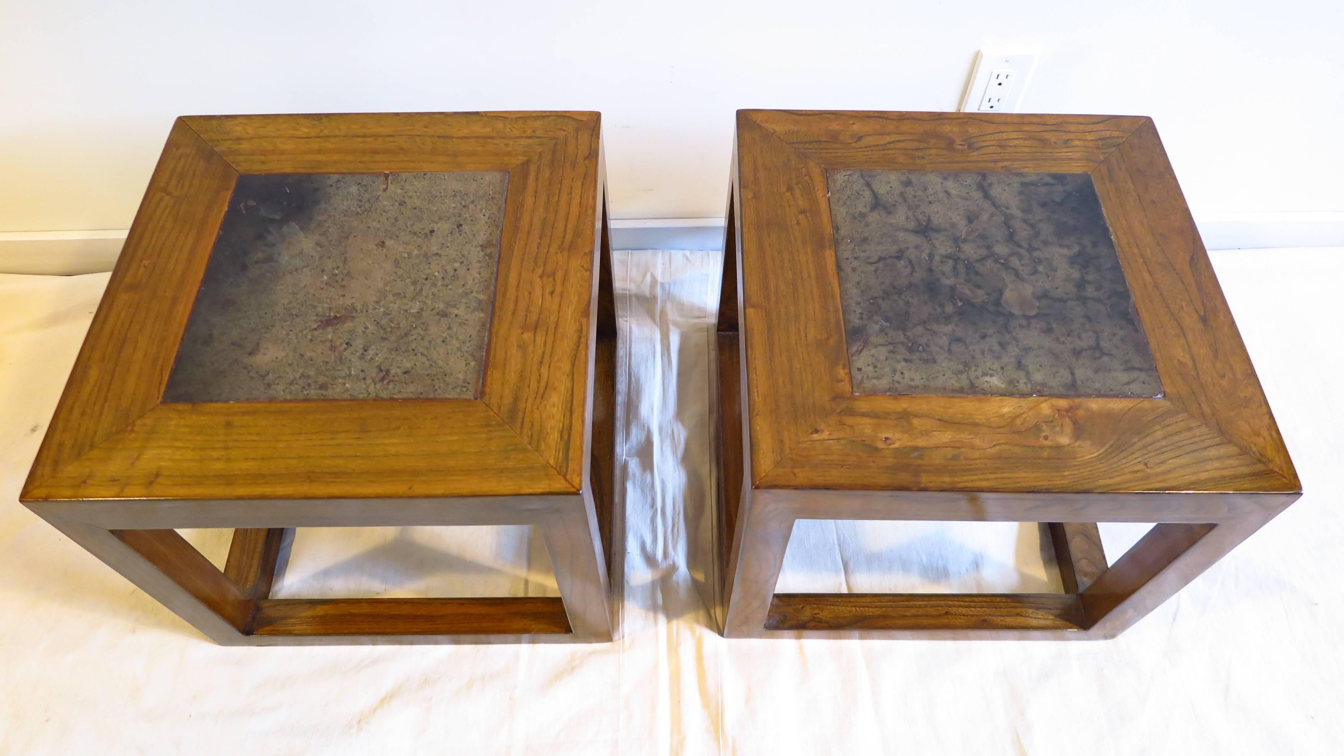 A pair of Elm wood cube tables with inset old stone tops. Very good condition,  Tops have variation in color, shading and darkness.  Varying  patina to the antique stone tops pictured.  
Can be used together as one table or as individual side