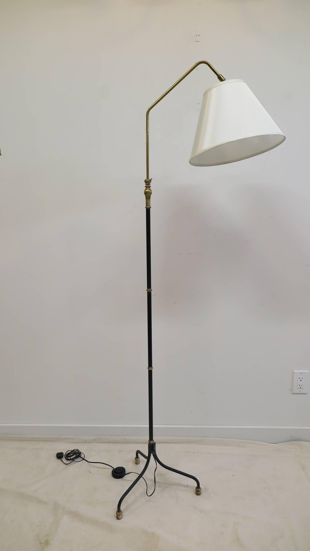 A 1950 iron and brass articulating French floor lamp in the style of Jean Royere. The shade has circular movement allowing a 3/4 angle, with adjustable height from 60 to 78 inches. Shade is silk measuring at 6 T x 14 B x10 slant. Very good