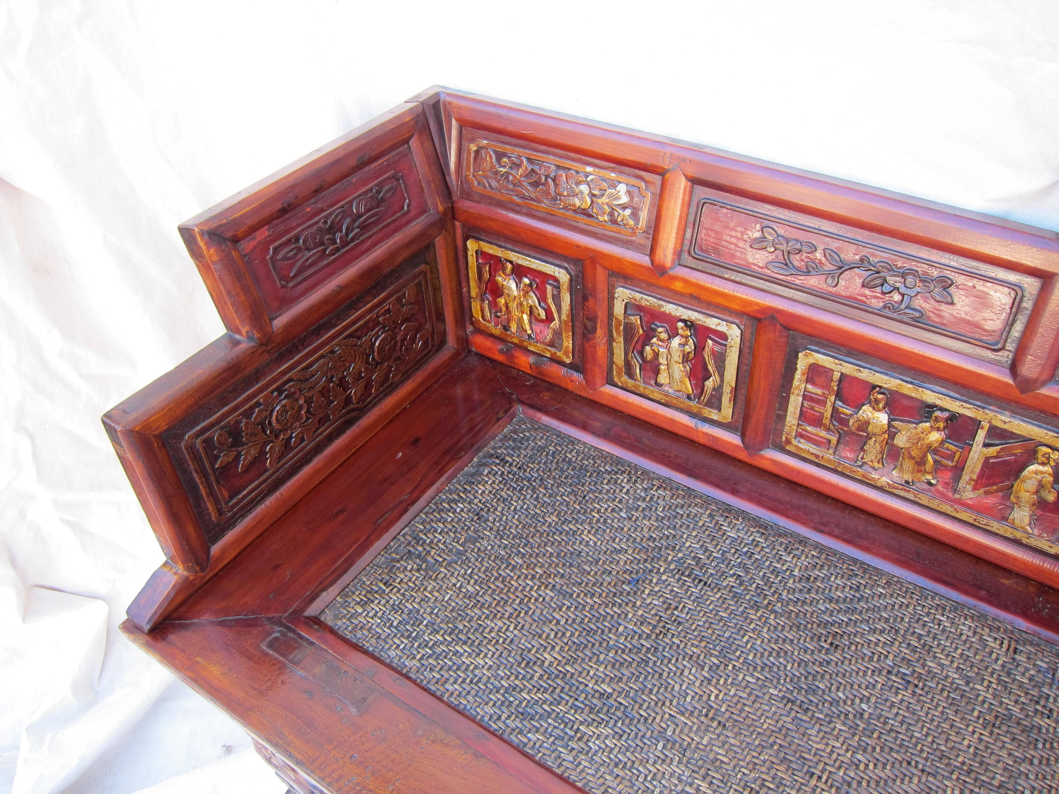 19th century Dynasty carved bench hall seat. Rattan topped seat with Elm and Cypress wood. Carved and glided with auspicious character scenes in story board. Lions heads cared to front legs. Two Foo Lions carved to the lower apron. A majestic