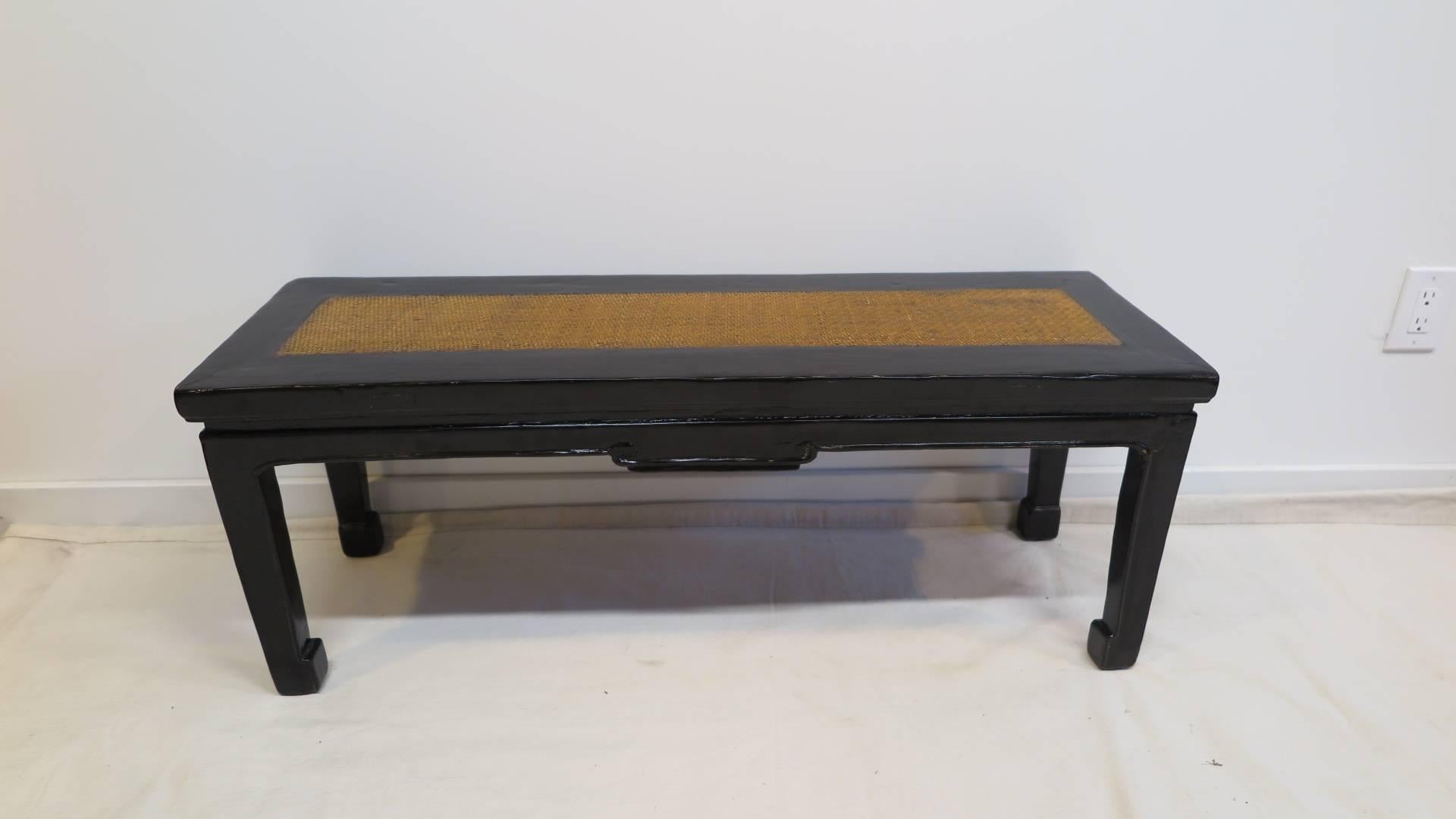 19th century Chinese bench. Elmwood with black lacquer and rattan set, horse hoof feet with carved detail to the aprons. Can be used for seating, or table. In very good condition. circa 1870.