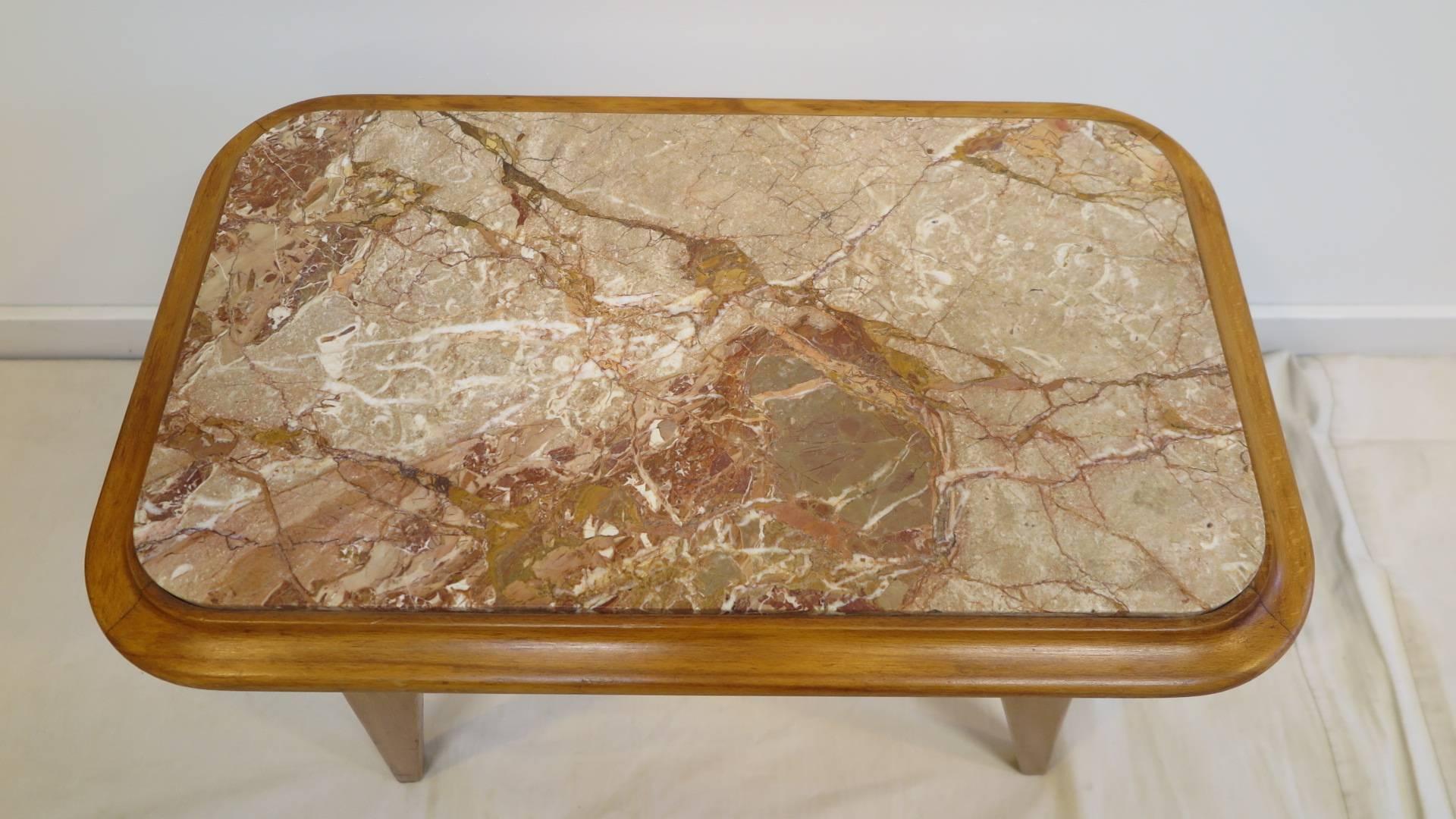 An Italian Midcentury Marble topped table.  Having splayed legs with a wonderful rose colored marble often referred to as Rouge Marble.  A mid century period table in very good condition.  Can be used as coffee table or end / side table.  Perfect
