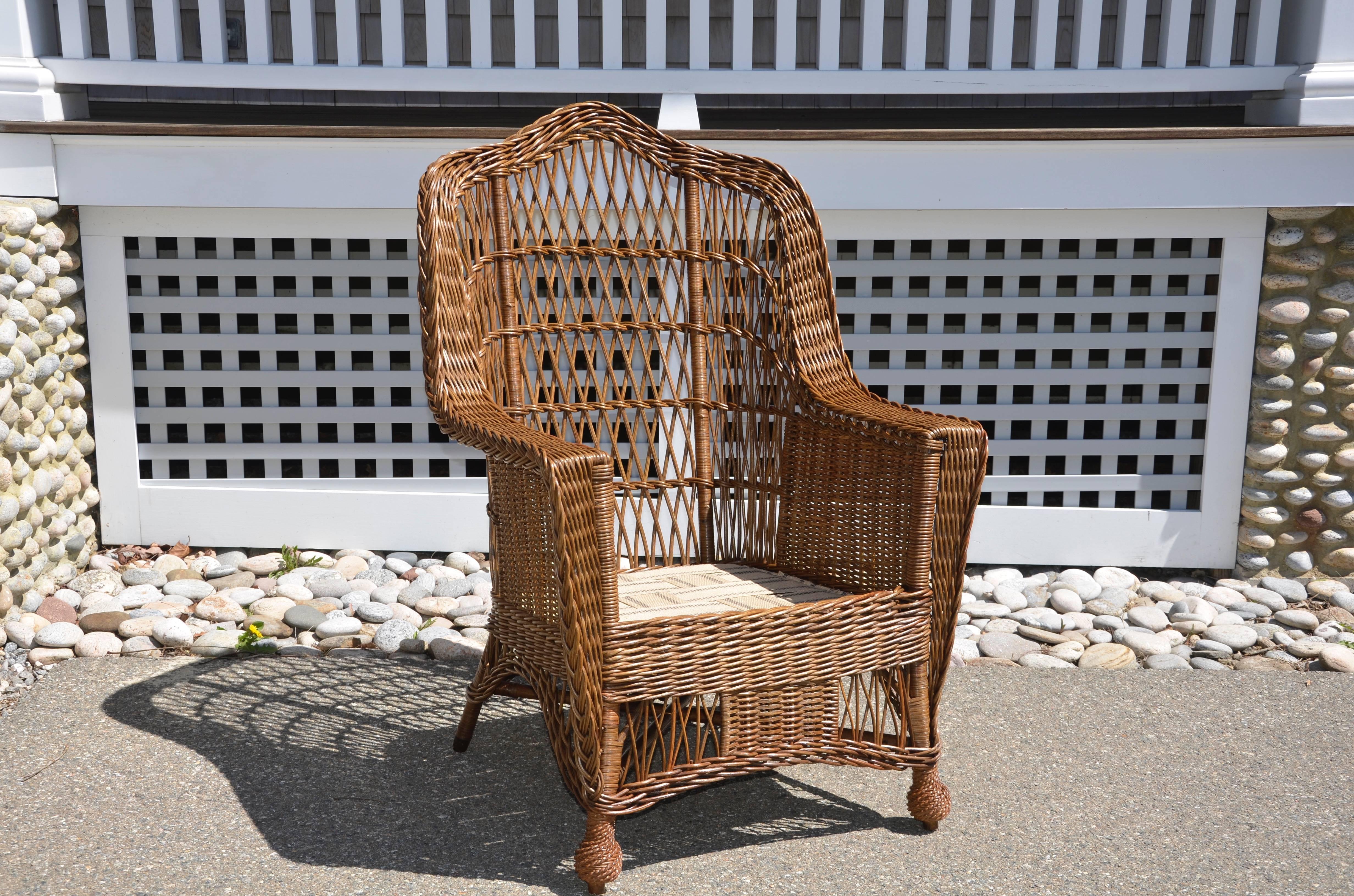 Classic antique Heywood-Wakefield armchair in a natural finish. Beautifully restored to original condition. A substantial and sturdy armchair that sits comfortably and accommodates most sizes.