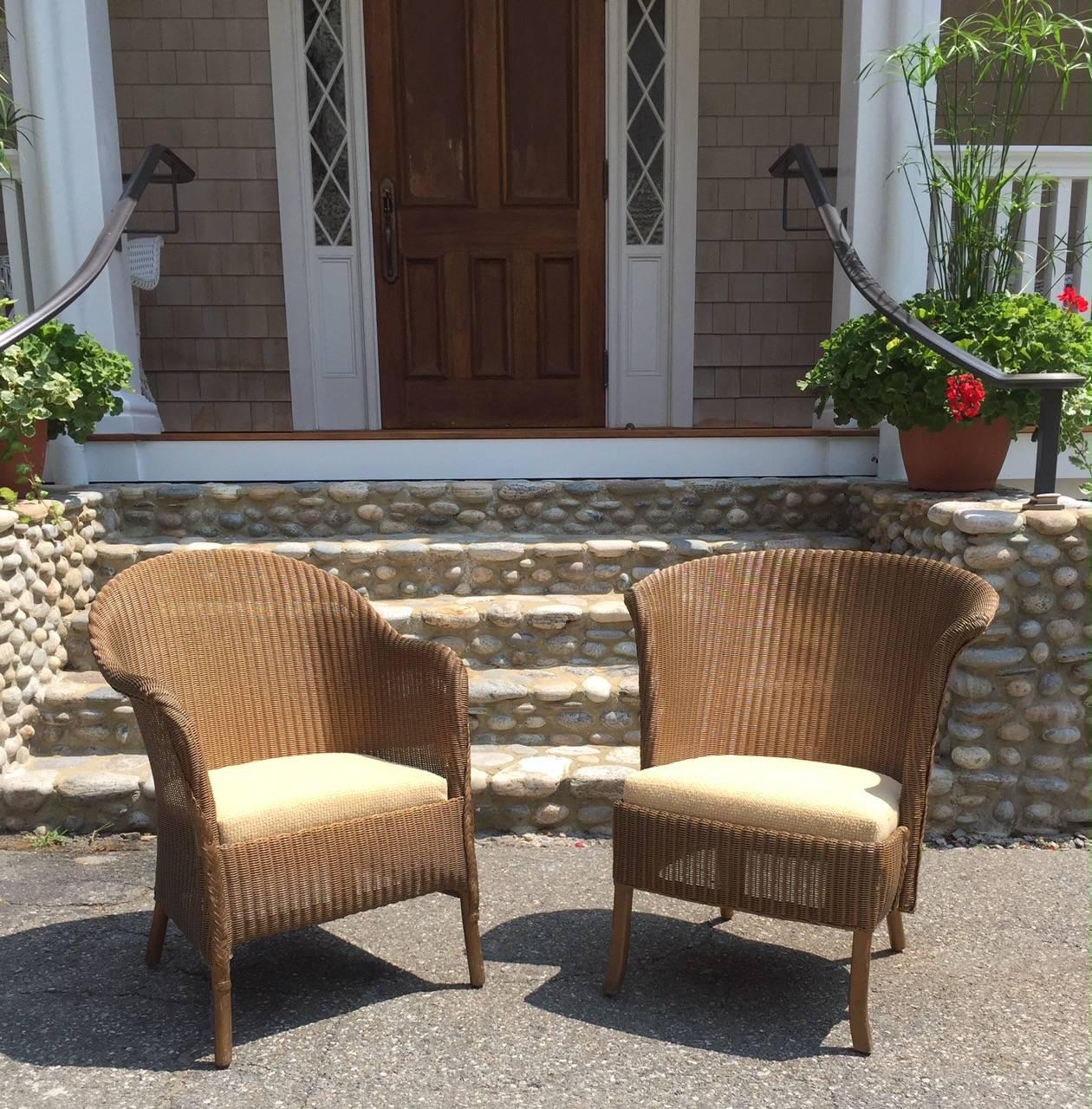 A pair of Lloyd Loom chairs by Lusty's of London in original finish. Recovered seats drop in to sit atop chair frames. Lovely and unique pair of woven chairs.

Larger chair measures 25
