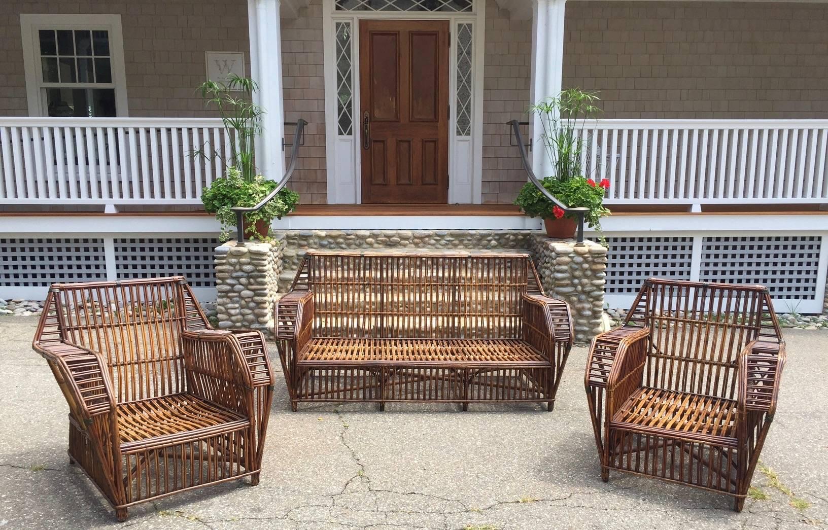 Antique stick rattan set in original natural finish. Chairs have integrated cup holders and magazine pockets.
Sofa measures 68
