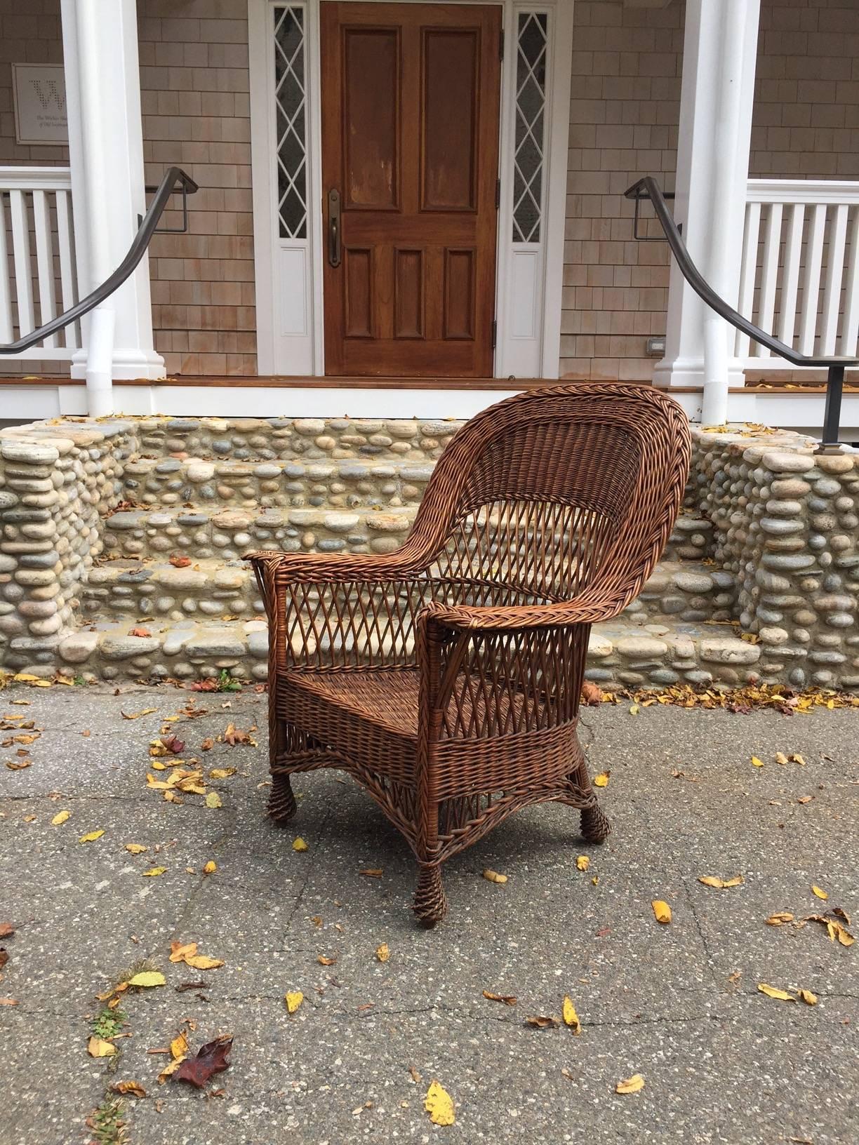Antique willow armchair with woven seat and feet in original natural finish. A rare and beautiful piece of antique wicker.