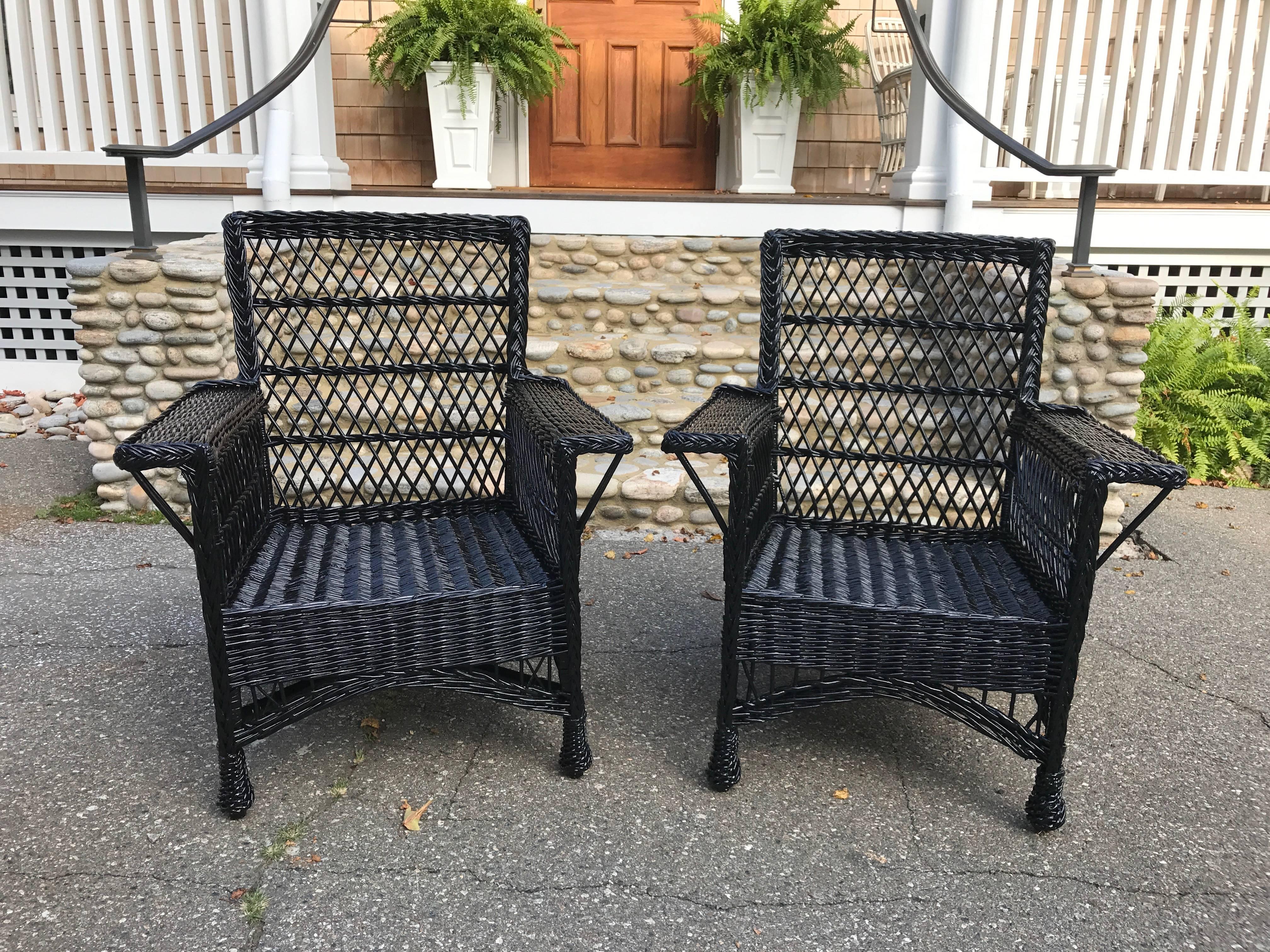 One pair of antique wicker chairs woven of willow in a Bar Harbor pattern and freshly painted black.