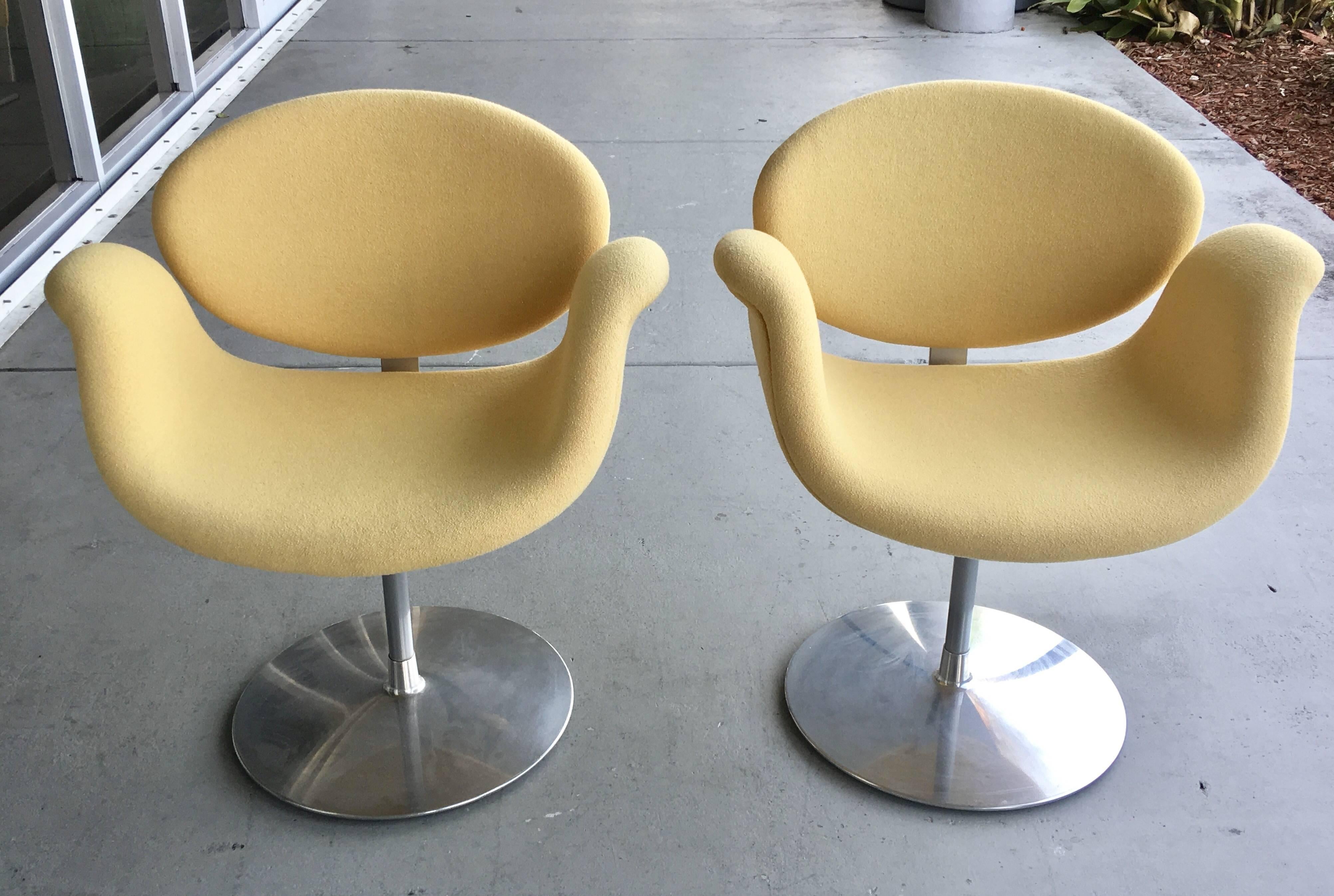 A pair of Pierre Paulin tulip chairs. Aluminum base with upholstered seats. The chairs have the original upholstery in great condition. Super comfortable and swivel.