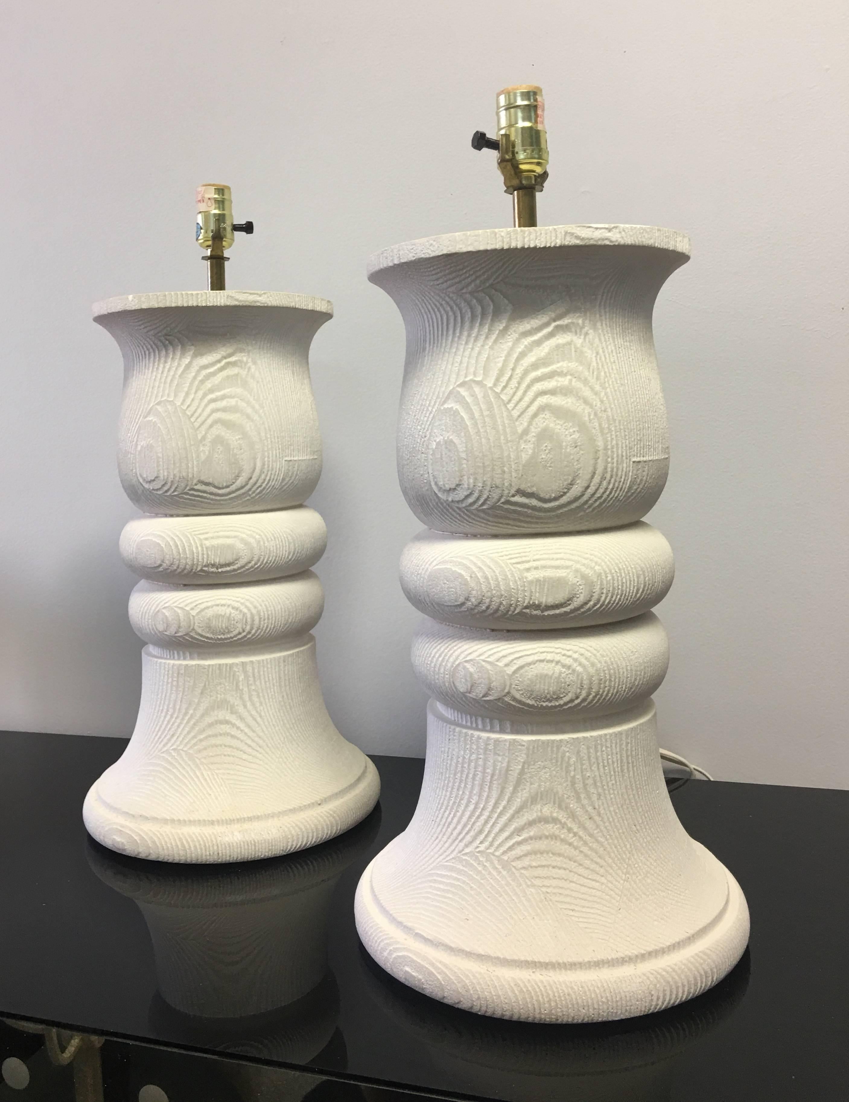 Large pair of plaster lamps. These are done in the surrealist style of John Dickinson. Substantial baluster shape with oak grain texture. Original molded finish, these lamps have not been re-coated and retain all the original detail.