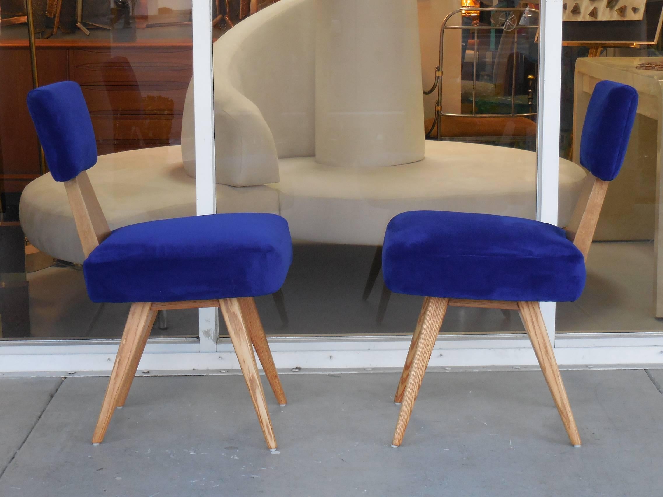 A pair of very early chairs. Flaring legs and geometric backs. These chairs are great looking and practical. An early example of Mr. Kagan's creative genius. Signed on seat under upholstery.