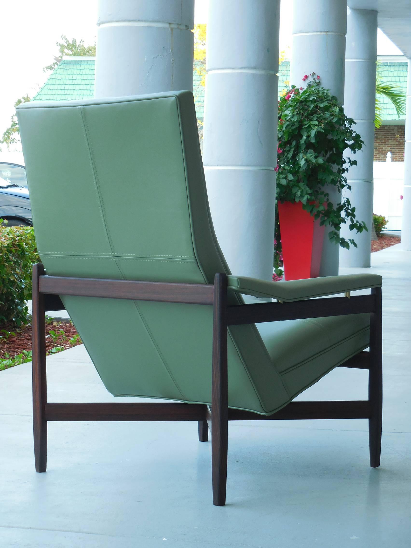 Rare pair of Midcentury Italian chairs. The upholstered seats balance on the solid rosewood frames. Note the angular armrests, floating on brass spacers. 