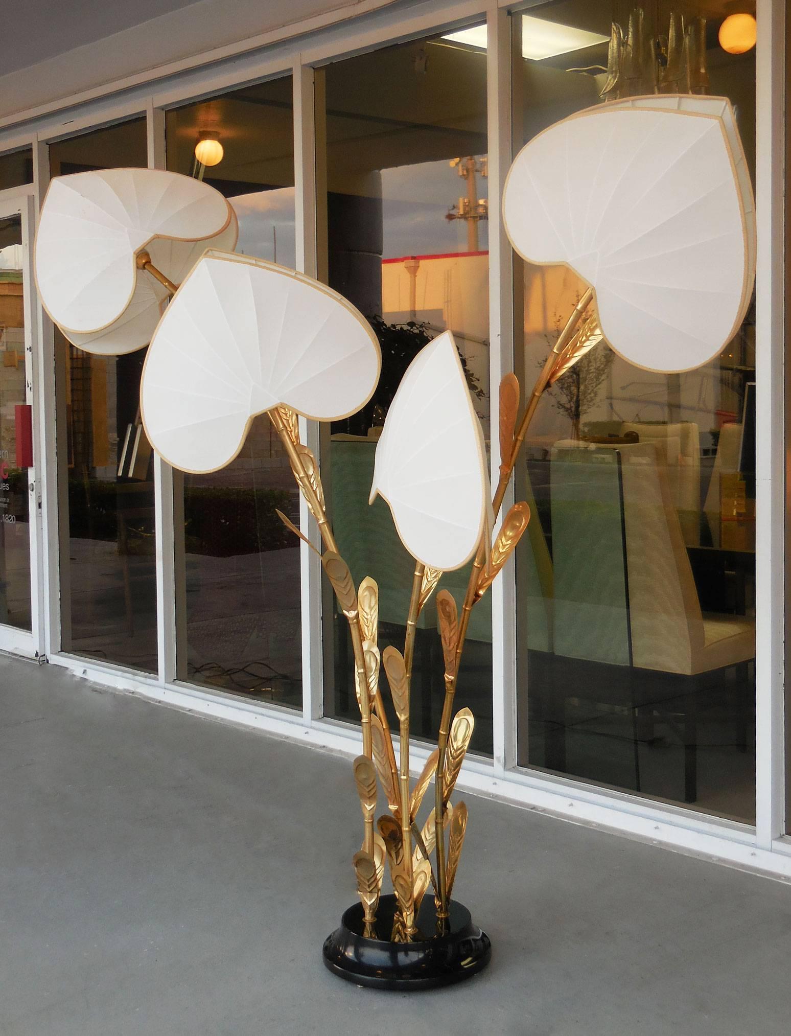Amazing Italian floor lamp. Gilt metal stems with leaves. Original double fabric shades conceal the light source. On a Bakelite base, signed with the brass inset 