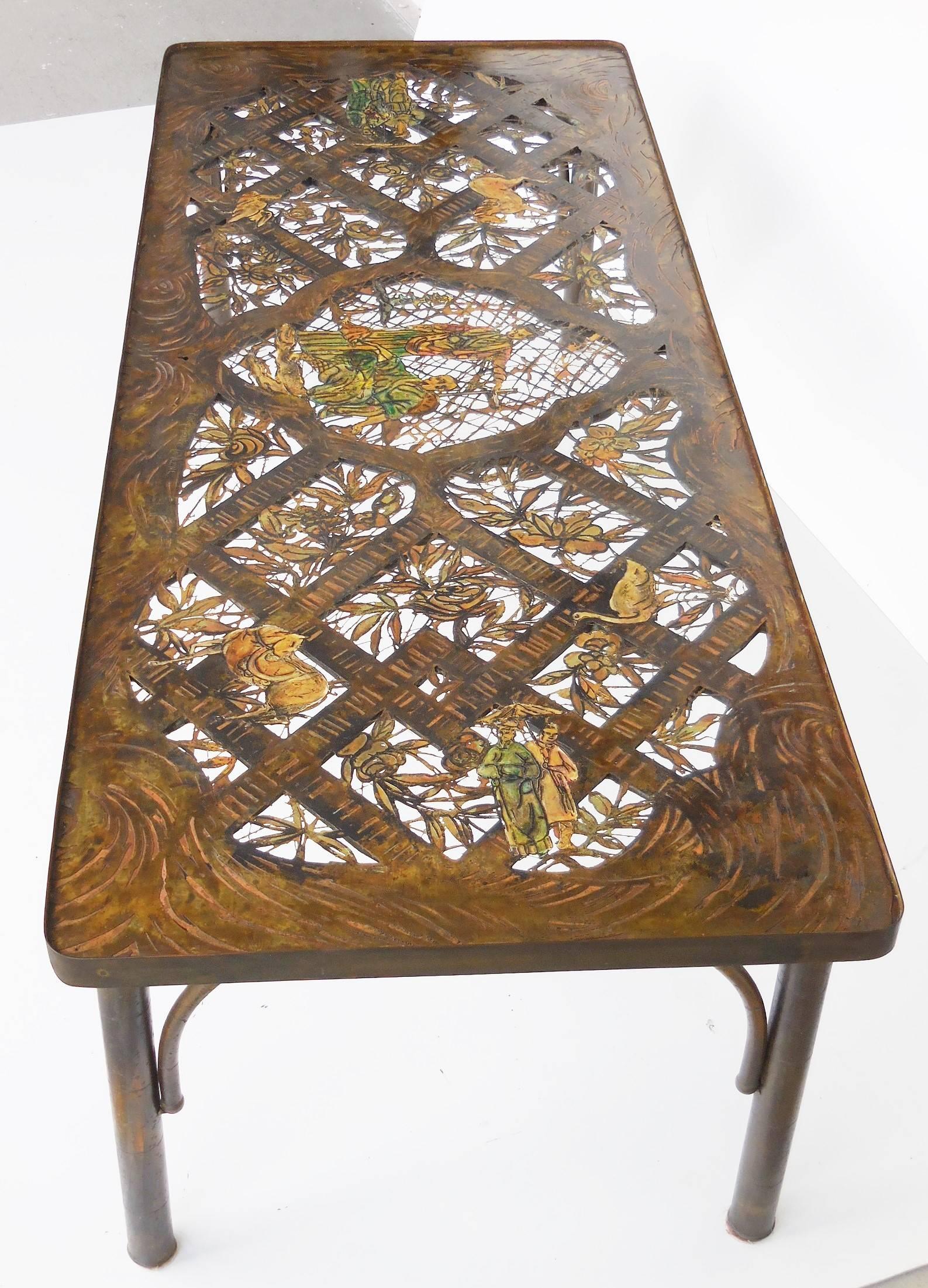 Exquisite and very unique coffee table by Philip and Kelvin LaVerne. The top has an intricate scene with cut-out and very fine detail. The condition is spectacular as the table retains the original glass top that has preserved the patinas and enamel