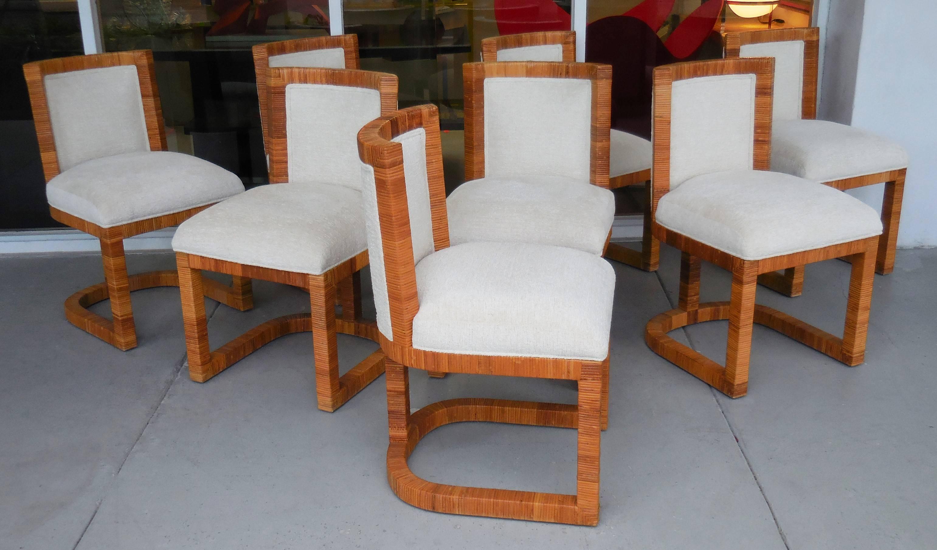 Stunning set of eight chairs. Casual elegance at it's best. Clean modern design, the wood frames are meticulously wrapped in rattan cane. Great looking from any angle. 
Casual elegance at it's best.
