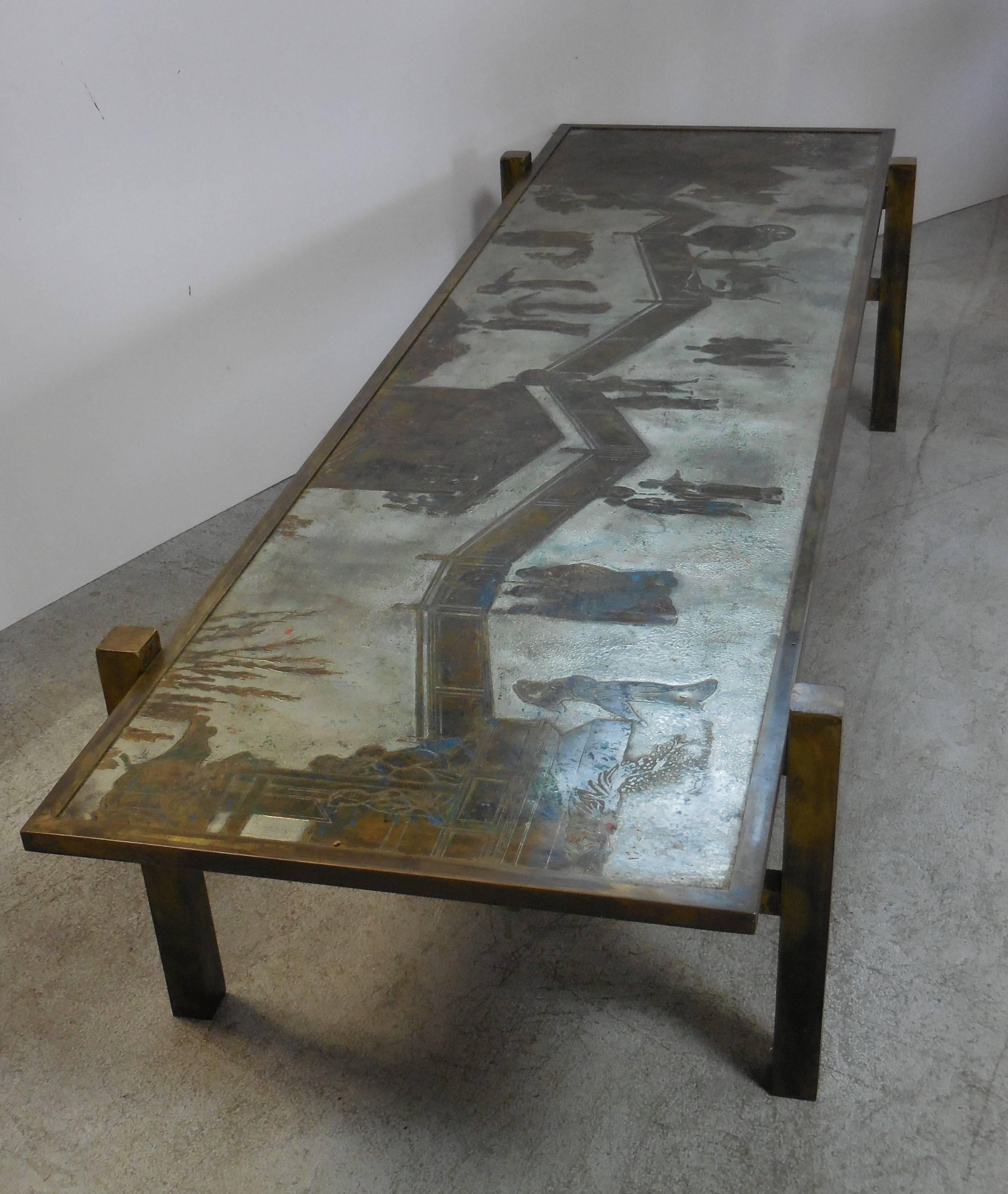 Beautiful coffee table by Philip and Kelvin LaVerne. Long and slender rectangular form with square legs and modernist frame. Bronze and pewter top with splashes of colorful enamel.