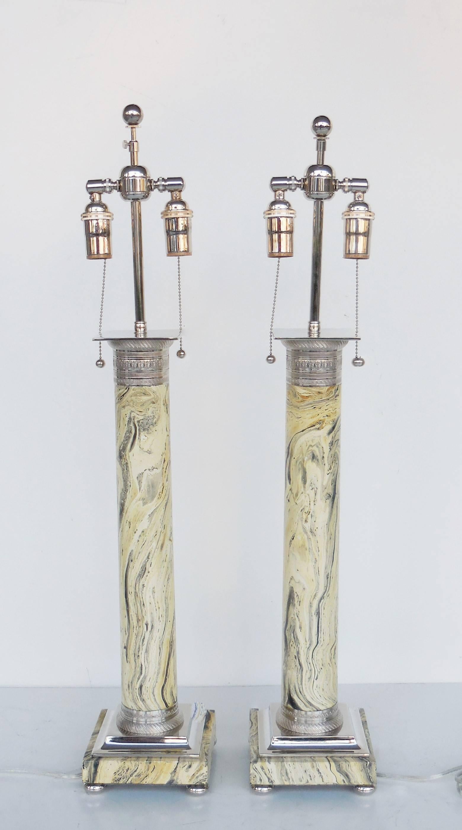 Great pair of Mid-Century lamps. Tall columns with very detailed faux marble decoration, the top and bottom of the columns are nickel plated bronze as well as the bun feet. Note the fine crisp detail on the capital and base. Completely restored and