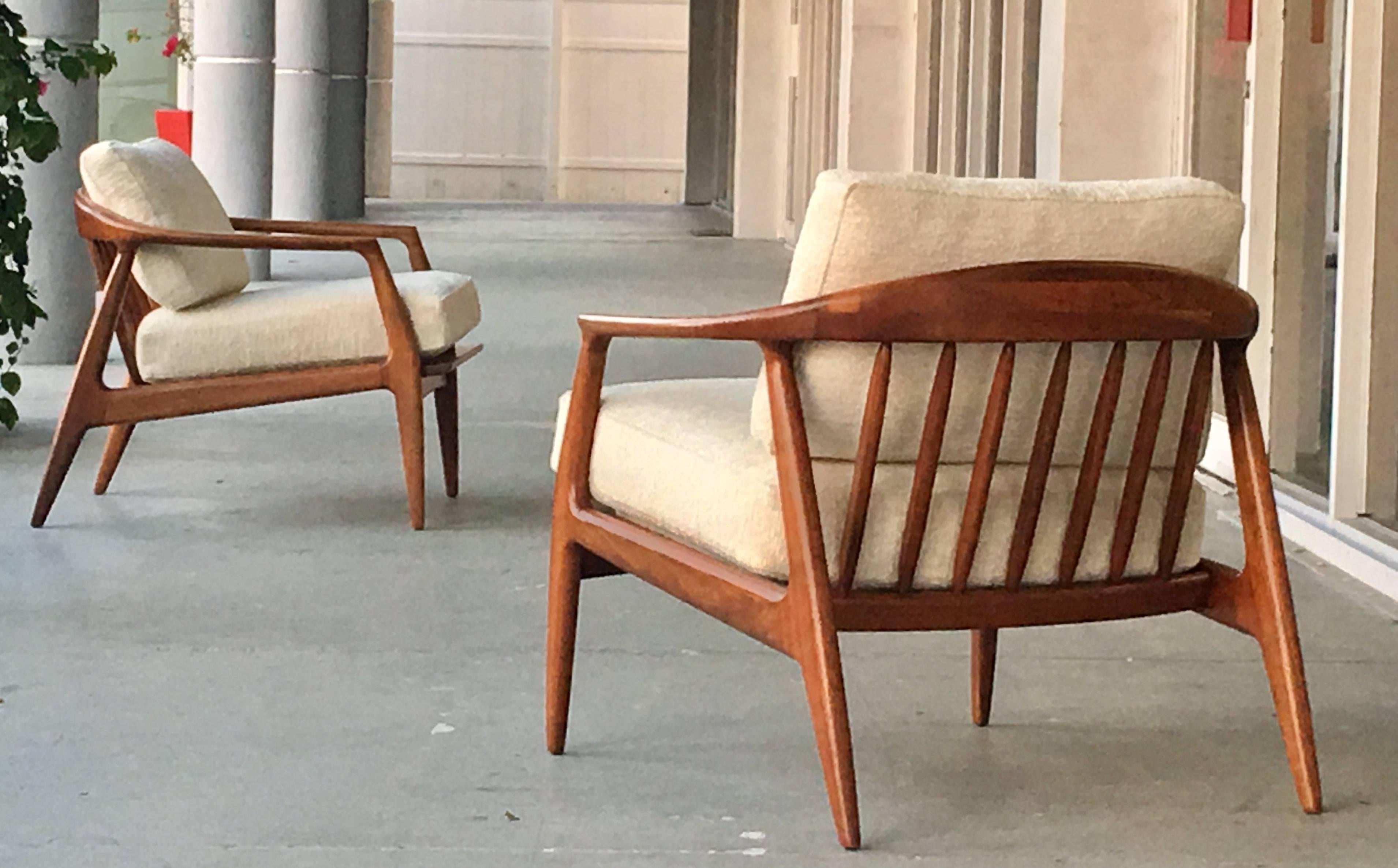 A pair of great looking lounge chairs by Milo Baughman. Solid walnut frames with removable cushions. Great lines and proportions. Two pairs available.