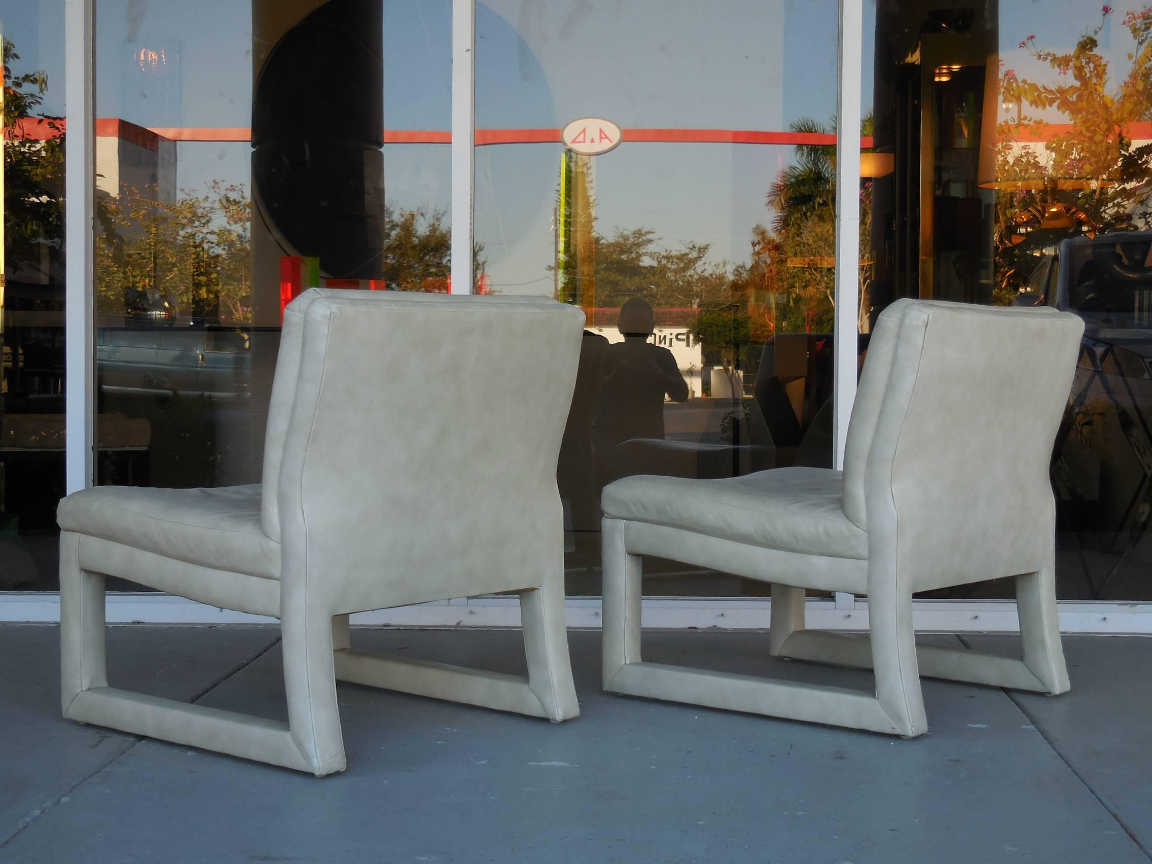 A pair of modern chairs with subtle Asian influences. The upholstery is the original leather. Very comfortable.