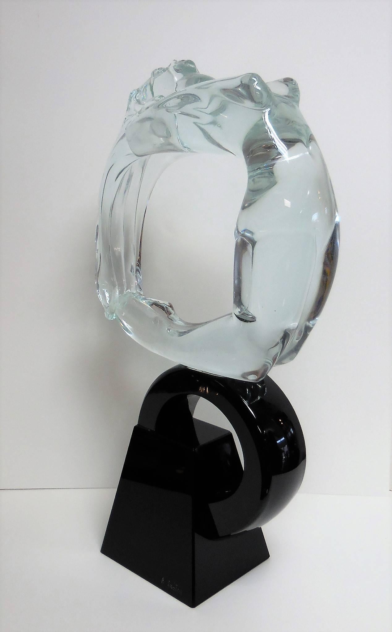 A large Art Deco style glass sculpture by Renato Anatra. A solid nude rests on a solid black glass base.
