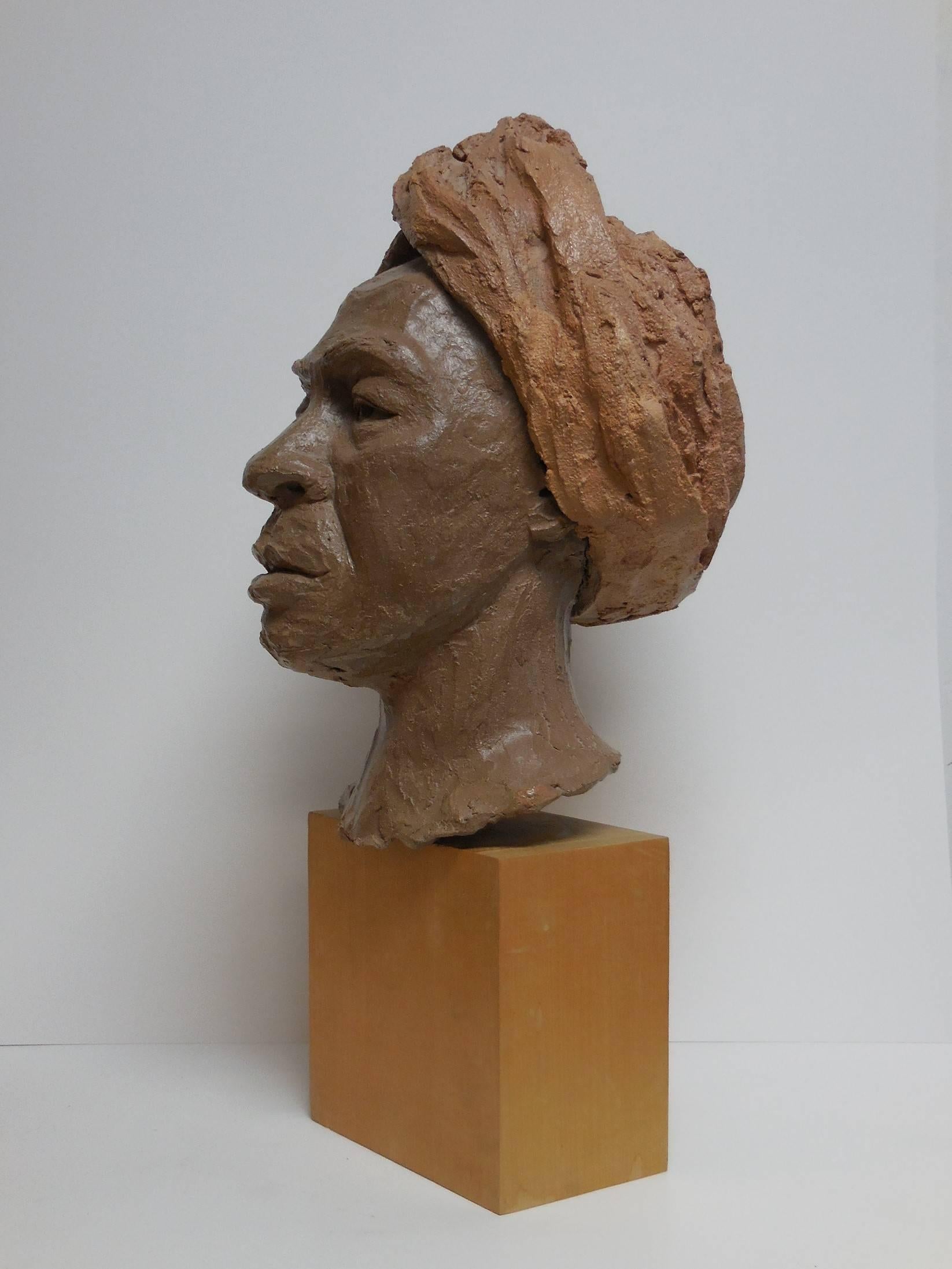 A life-size sculpture, terracotta on a wood base. Extremely well done with lots of detail. Signed on back. Head is 14