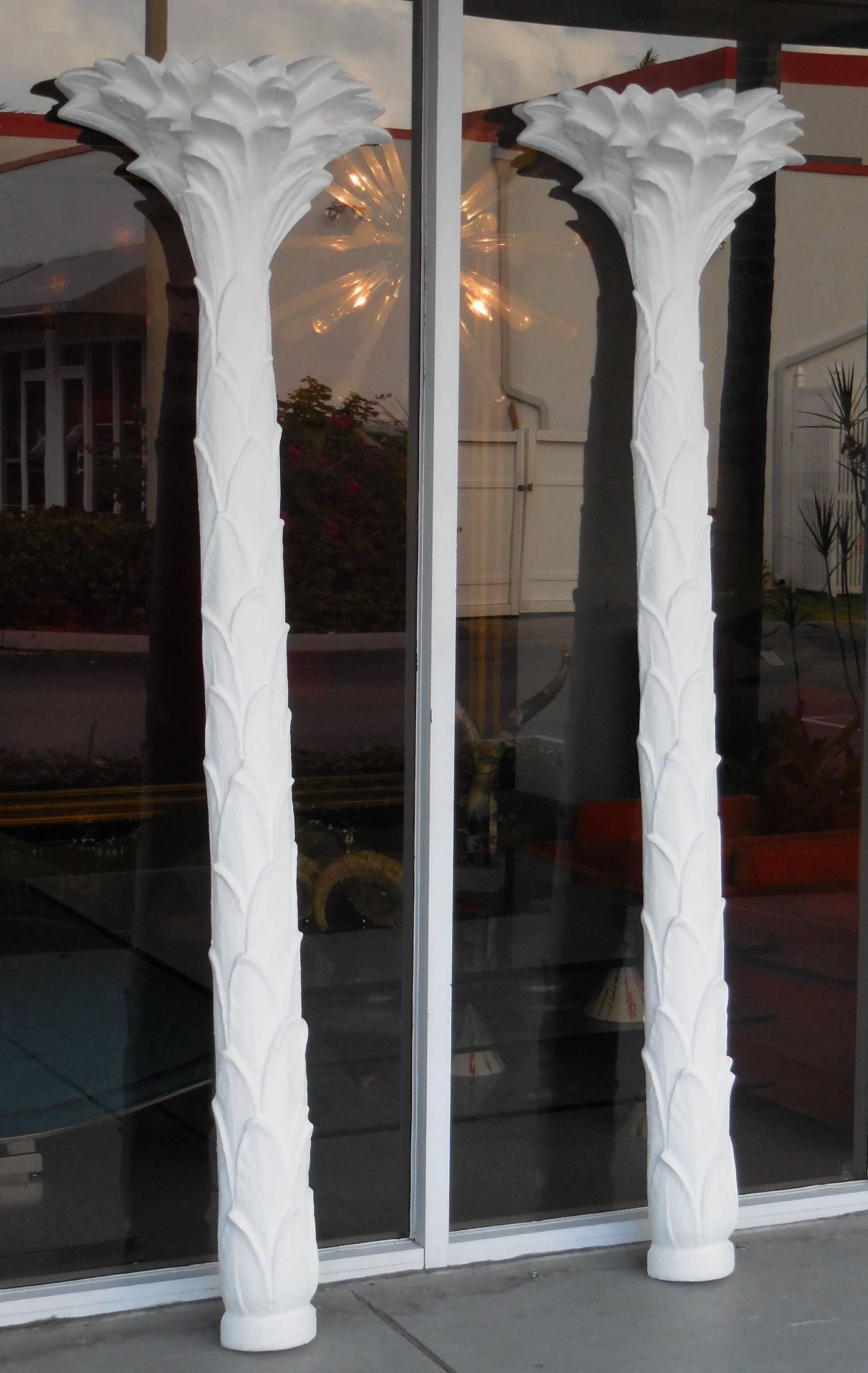 A pair of stylized palm tree Floor lamps by Sirmos. Made to be instaled flat on the wall to add a lot of style to any room. Retain label to back. In working order, each one takes two regular bulbs.