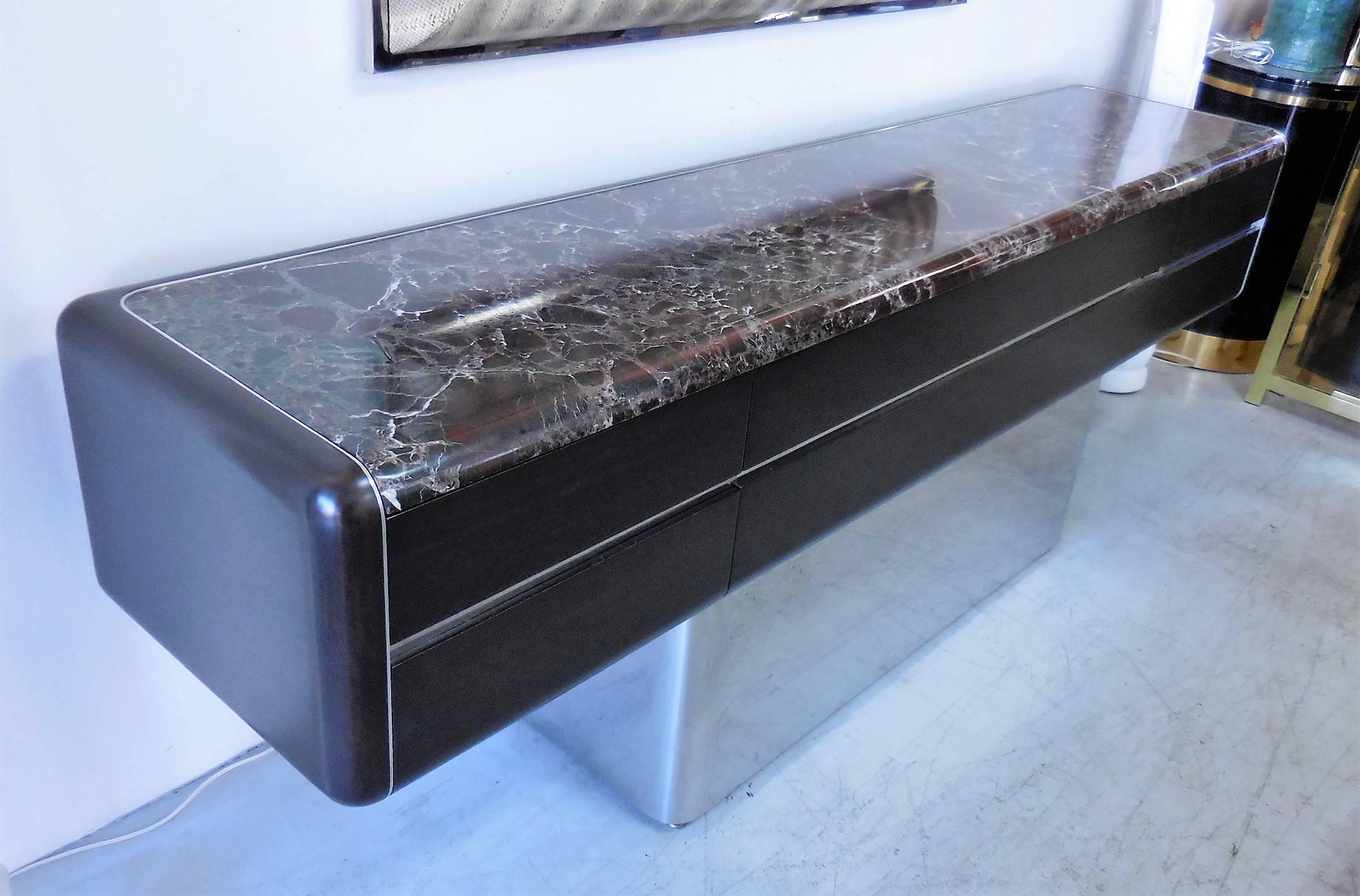 Stunning cabinet by Vladimir Kagan. Wood case on a polished stainless steel base and a fitted marble top. Clean and modern elegant design with lots of storage. Five drawers total. The original marble top is fitted. Signed with label on drawer.