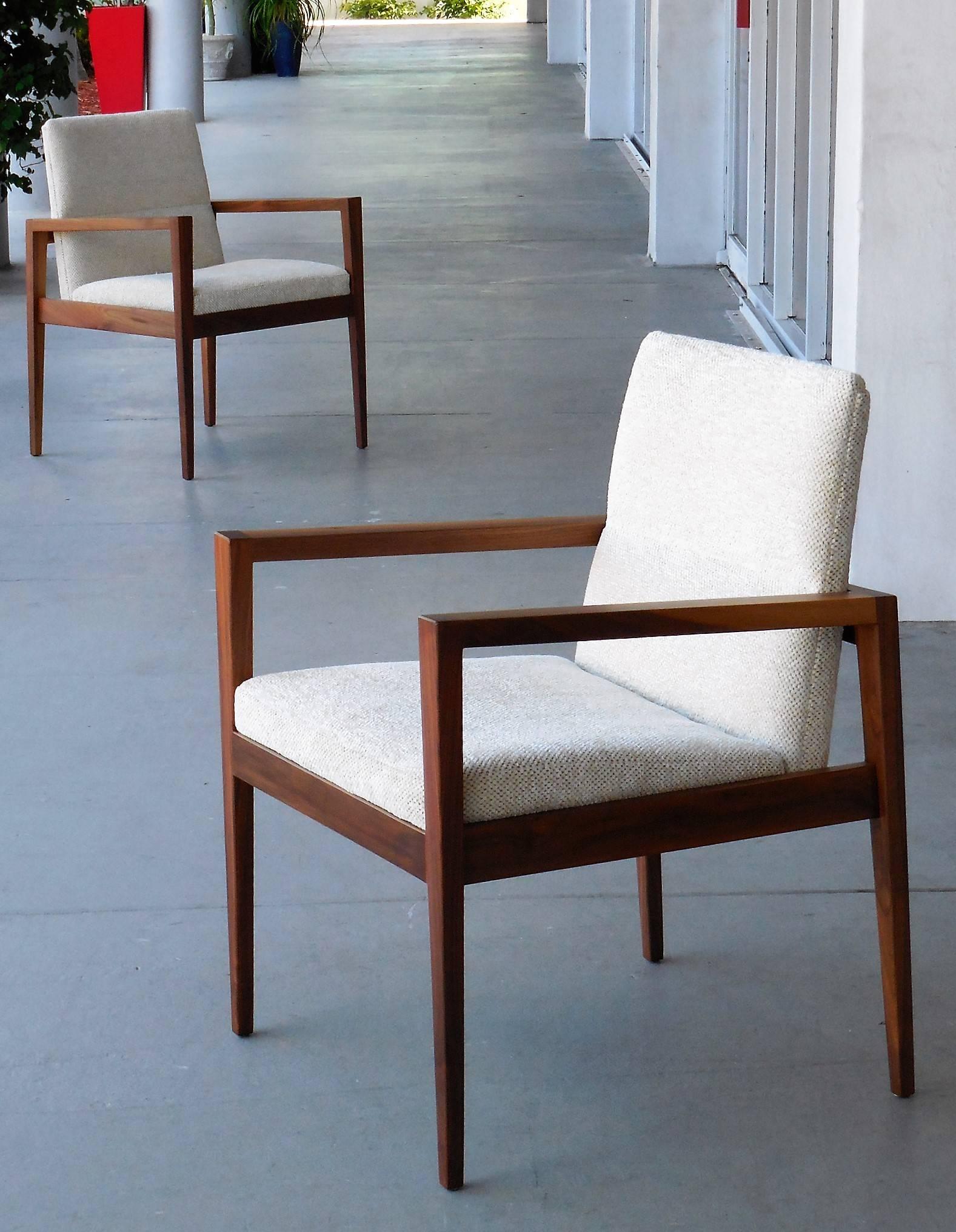 Pair of chairs by Jens Risom. Solid walnut frames with upholstered seats. Handsome design with amazing grain on the wood.