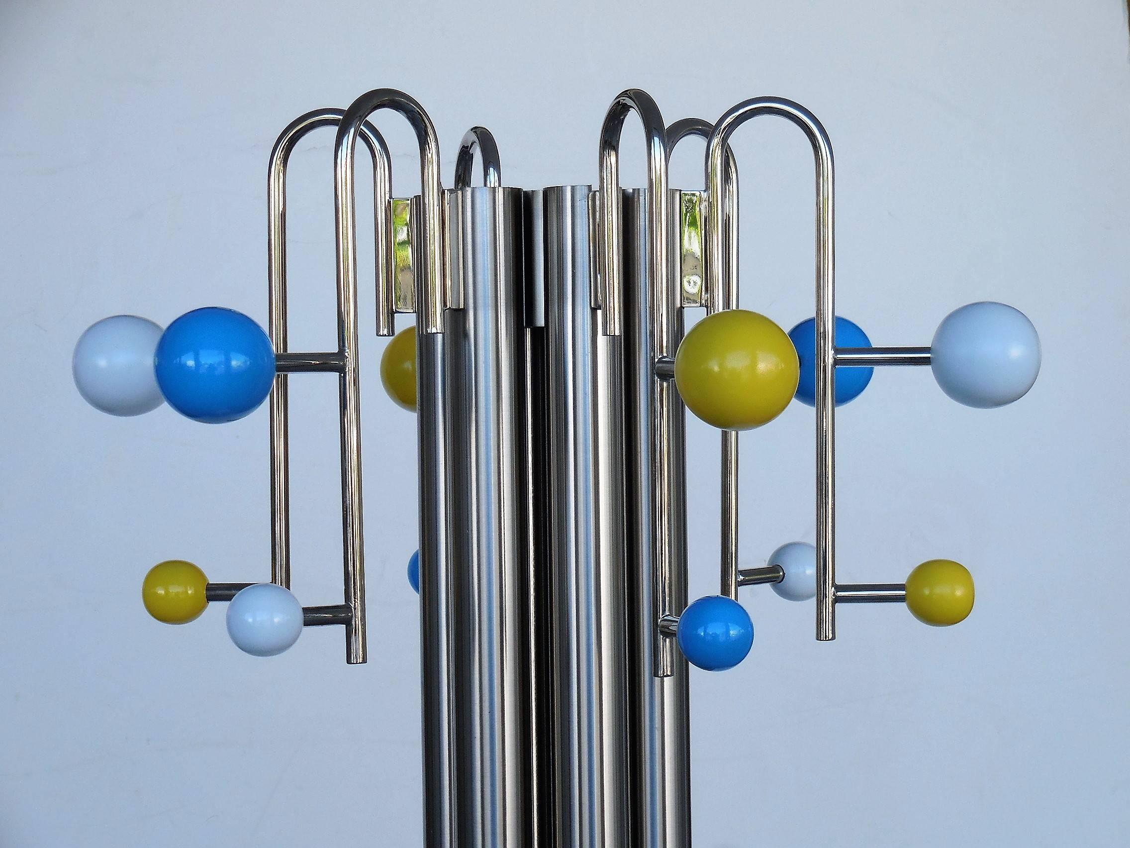 A wonderful postmodern coat rack. Brushed and polish with colorful wood balls, the base is marble. The shaft is brushed and the hooks with the balls are polished.