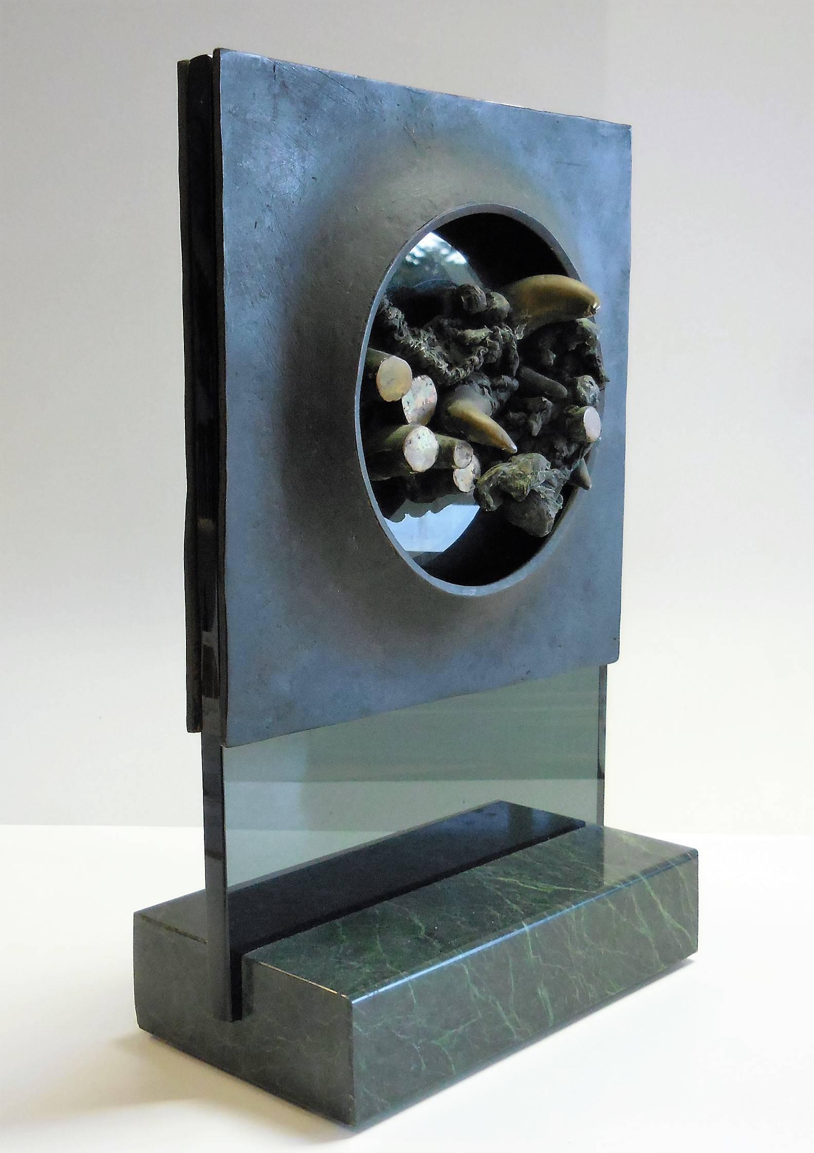 A unique sculpture by artist Dean Meeker. The sculpture has two sides that although very similar offer subtle differences. Both sides have heavy bronze portholes mounted on smoked glass that offer a view of multiple bronze elements. The unusual