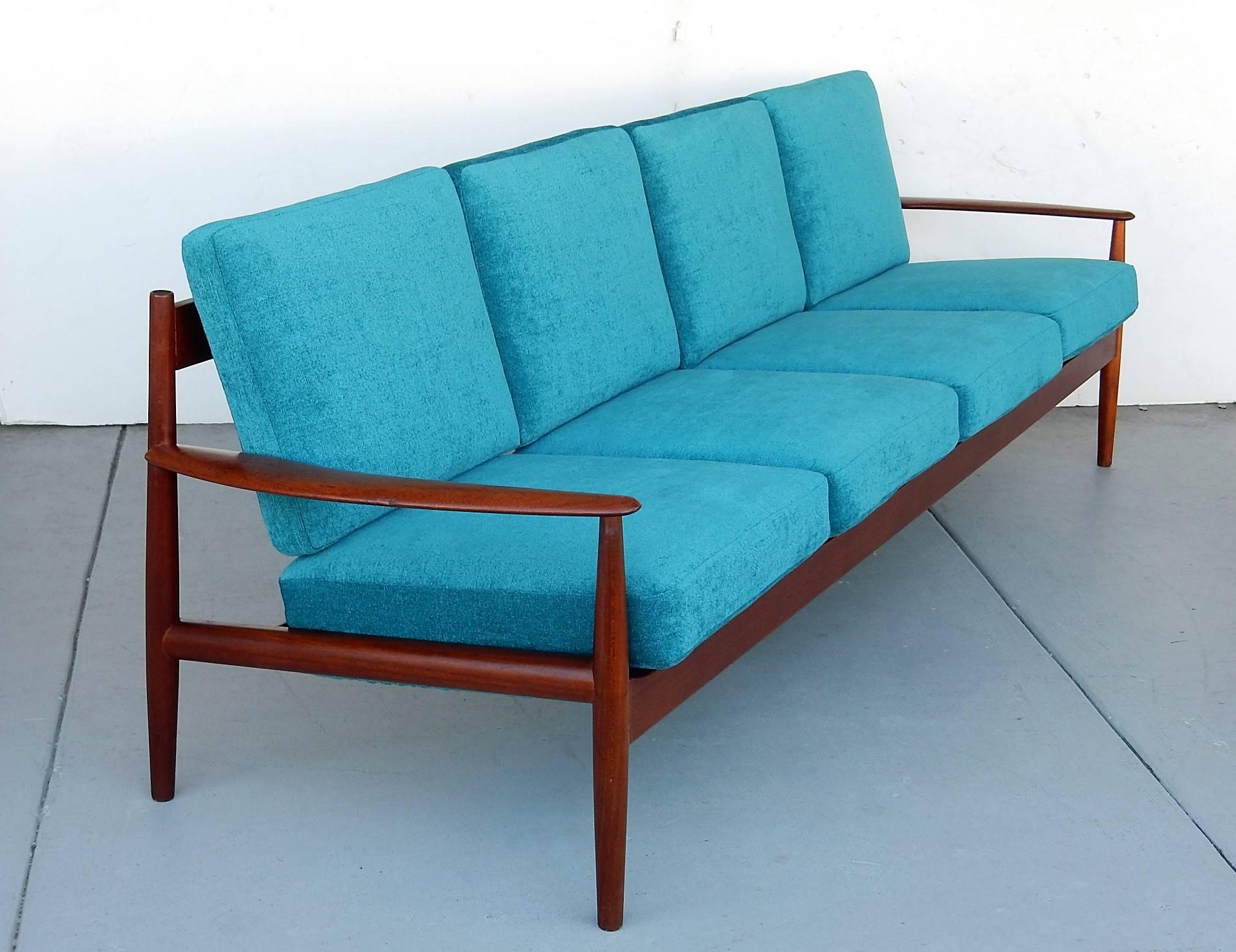 An early example of the Classic Grete Jalk sofa. Solid teak frame with new turquoise chenille upholstery. Retains the original spring cushions.