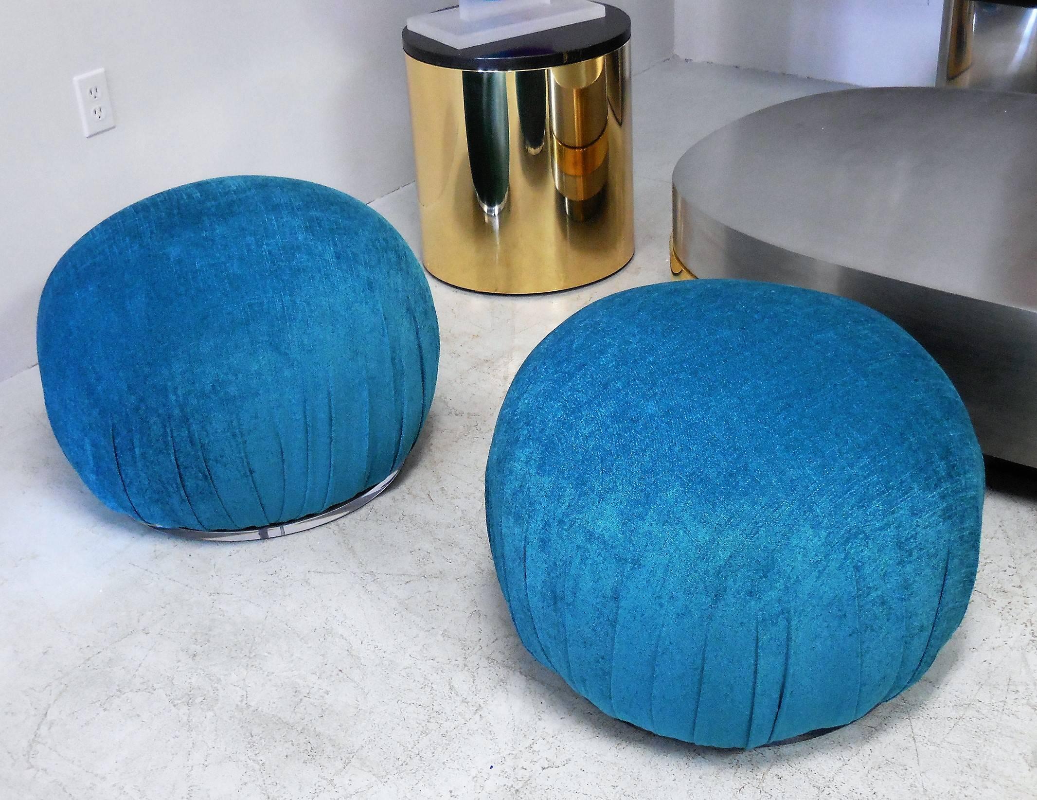 A pair of round pouf stools or ottomans with Lucite bases. Quite comfortable and stylish. Re-done in soft turquoise chenille.