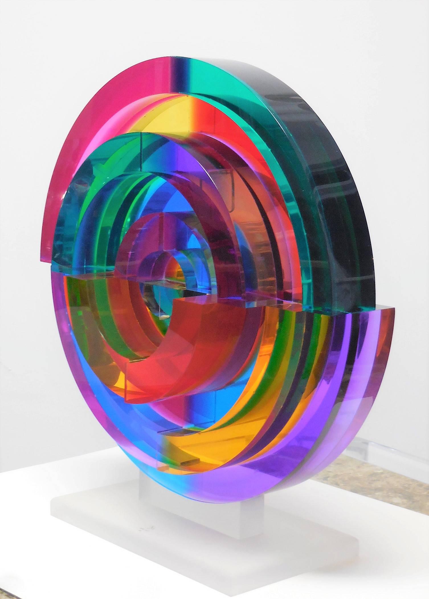Amazing to say the least. This Lucite sculpture is colorful as well as having a substantial presence and unexpected design. Multiple radial pieces are arranged in a concentric design with different depths and color combinations. Spectacular if